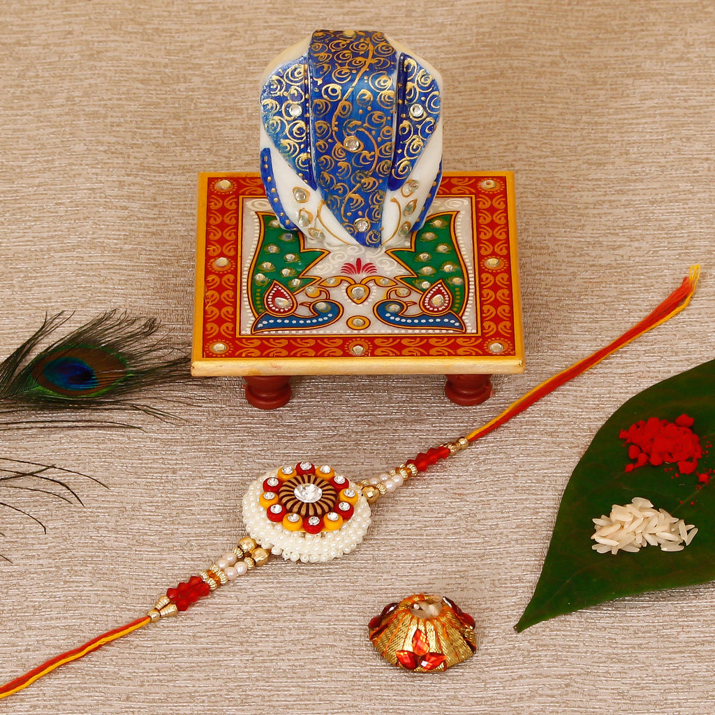 Designer Rakhi with Lord Ganesha on Marble Chowki and Roli Tikka Matki Kafalo