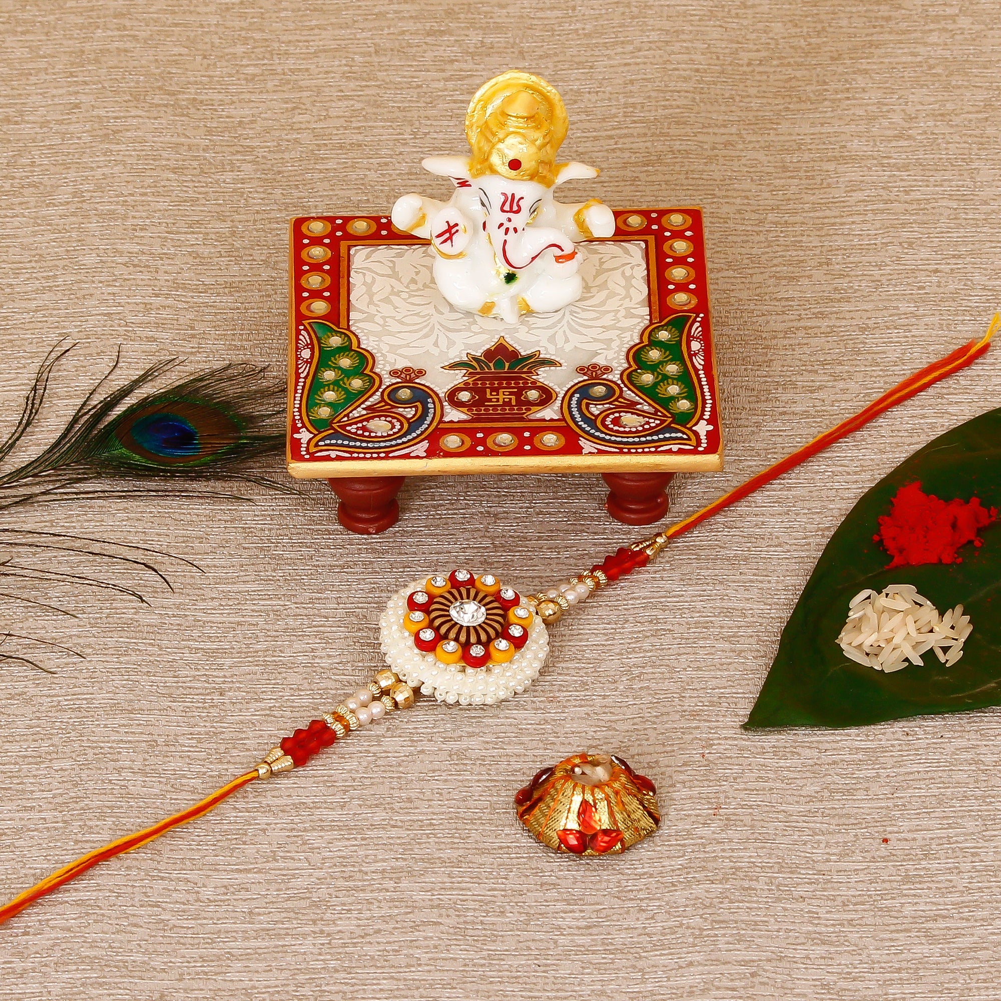 Designer Rakhi with Lord Ganesha Marble Chowki and Roli Tikka Matki Kafalo