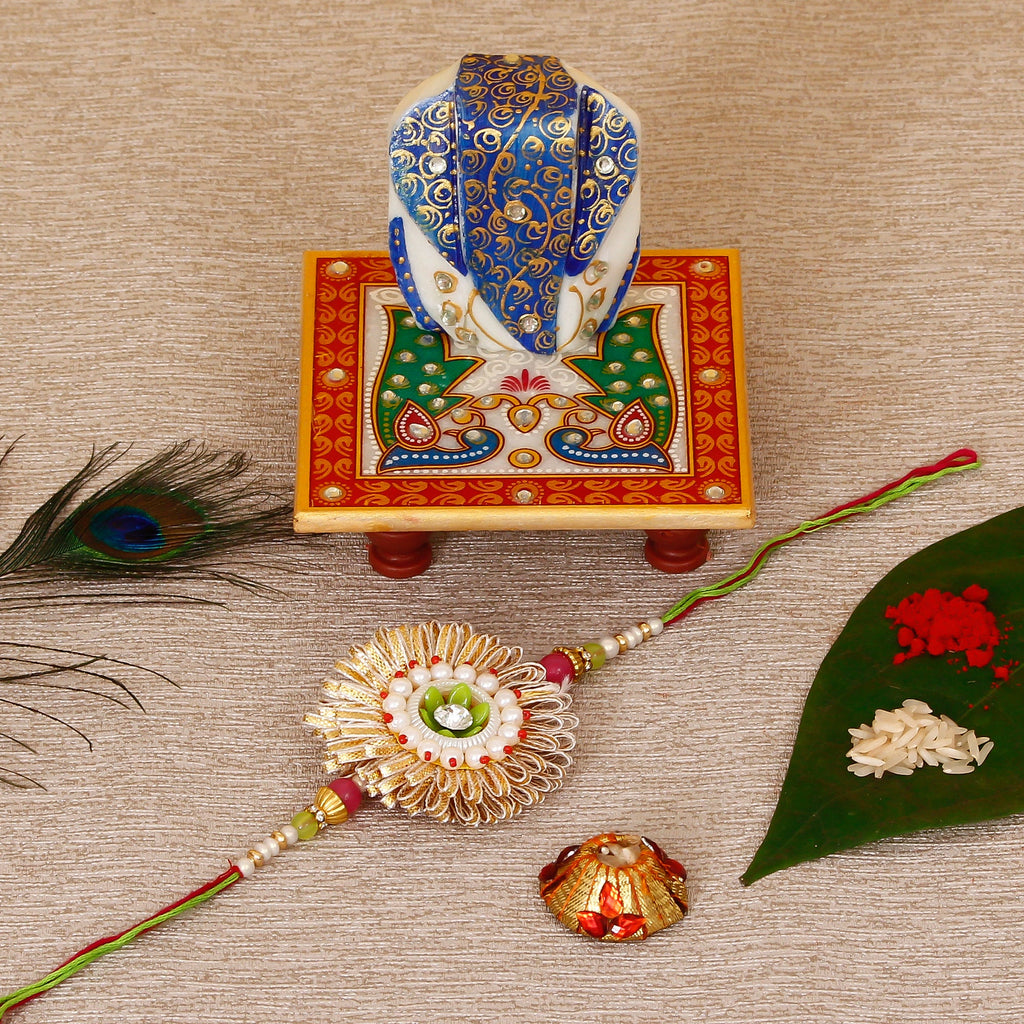 Designer Rakhi with Lord Ganesha on Marble Chowki and Roli Tikka Matki Kafalo