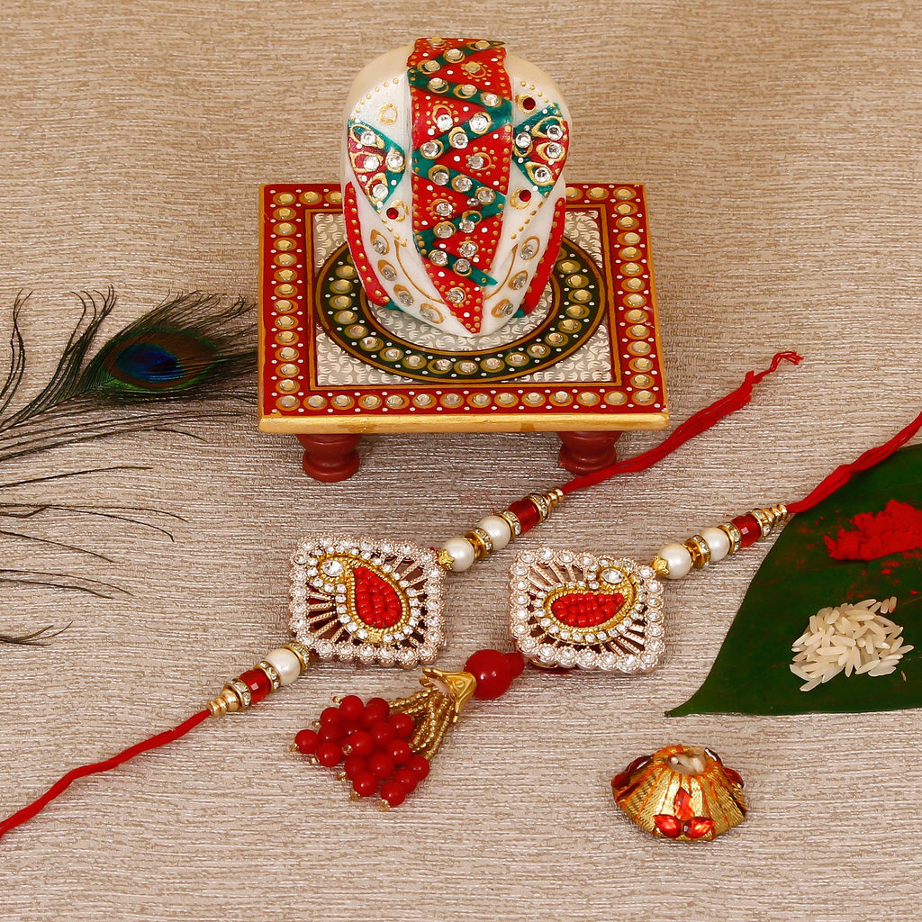 Designer Bhaiya Bhabhi Rakhi with Lord Ganesha on Kundan Studded Marble Chowki and Roli Tikka Matki Kafalo