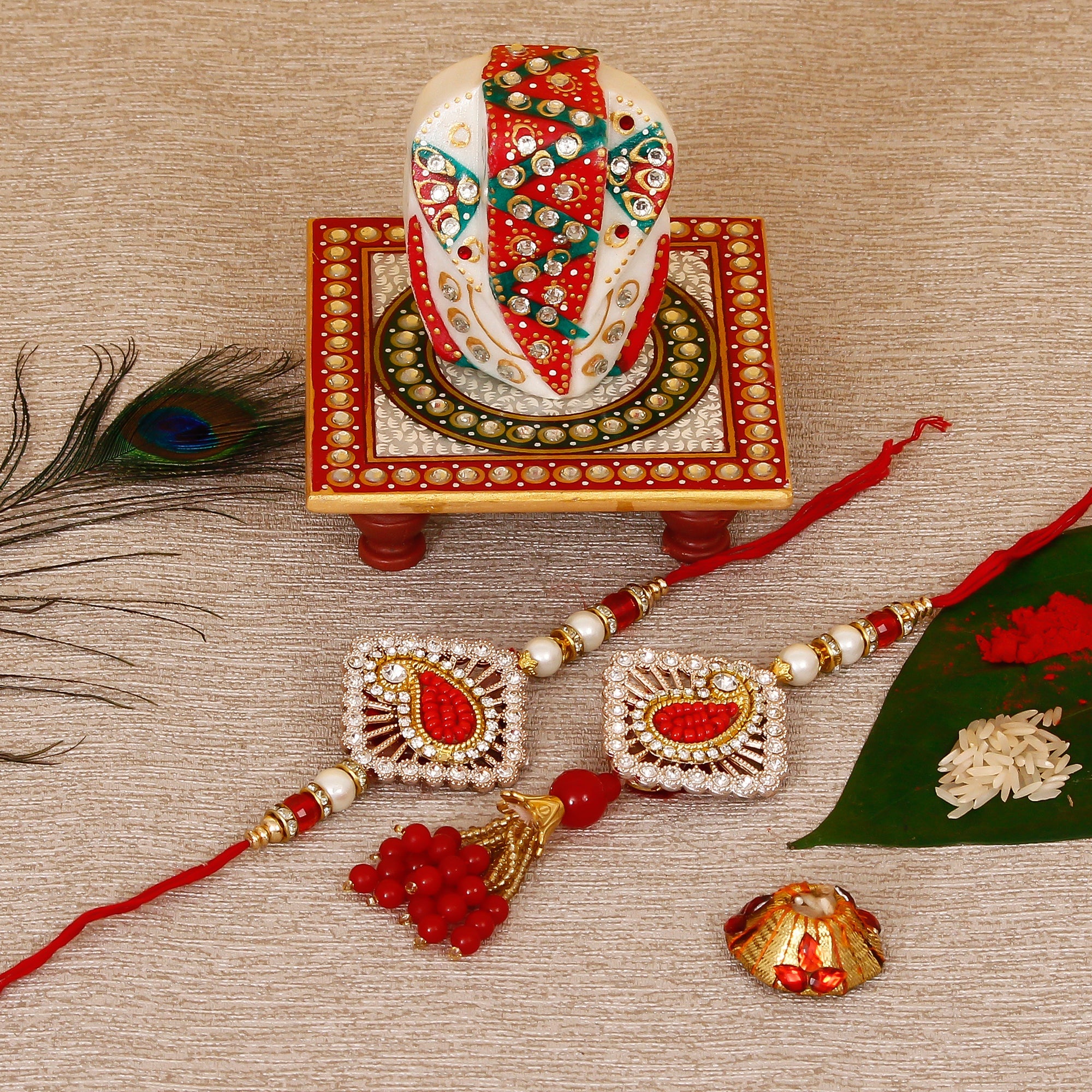 Designer Bhaiya Bhabhi Rakhi with Lord Ganesha on Kundan Studded Marble Chowki and Roli Tikka Matki Kafalo