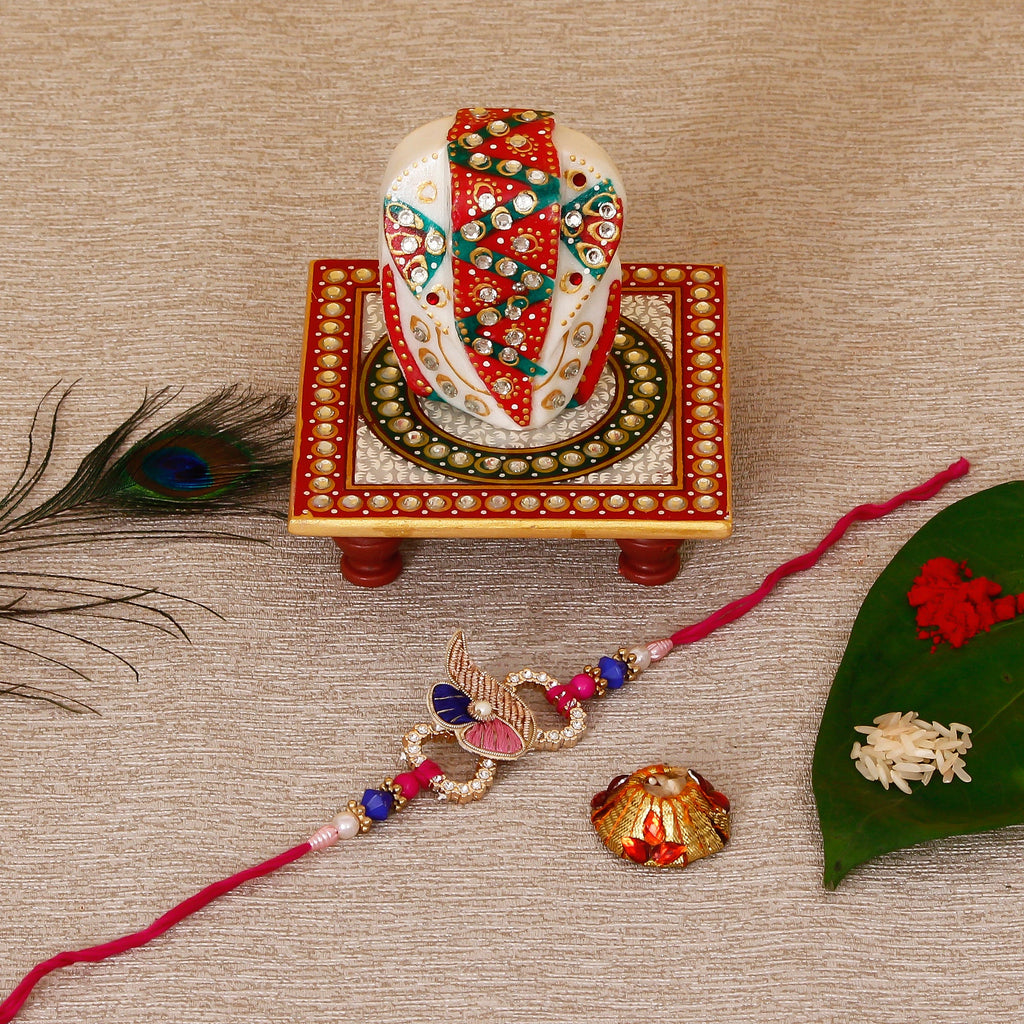 Designer Rakhi with Lord Ganesha on Kundan Studded Marble Chowki and Roli Tikka Matki Kafalo