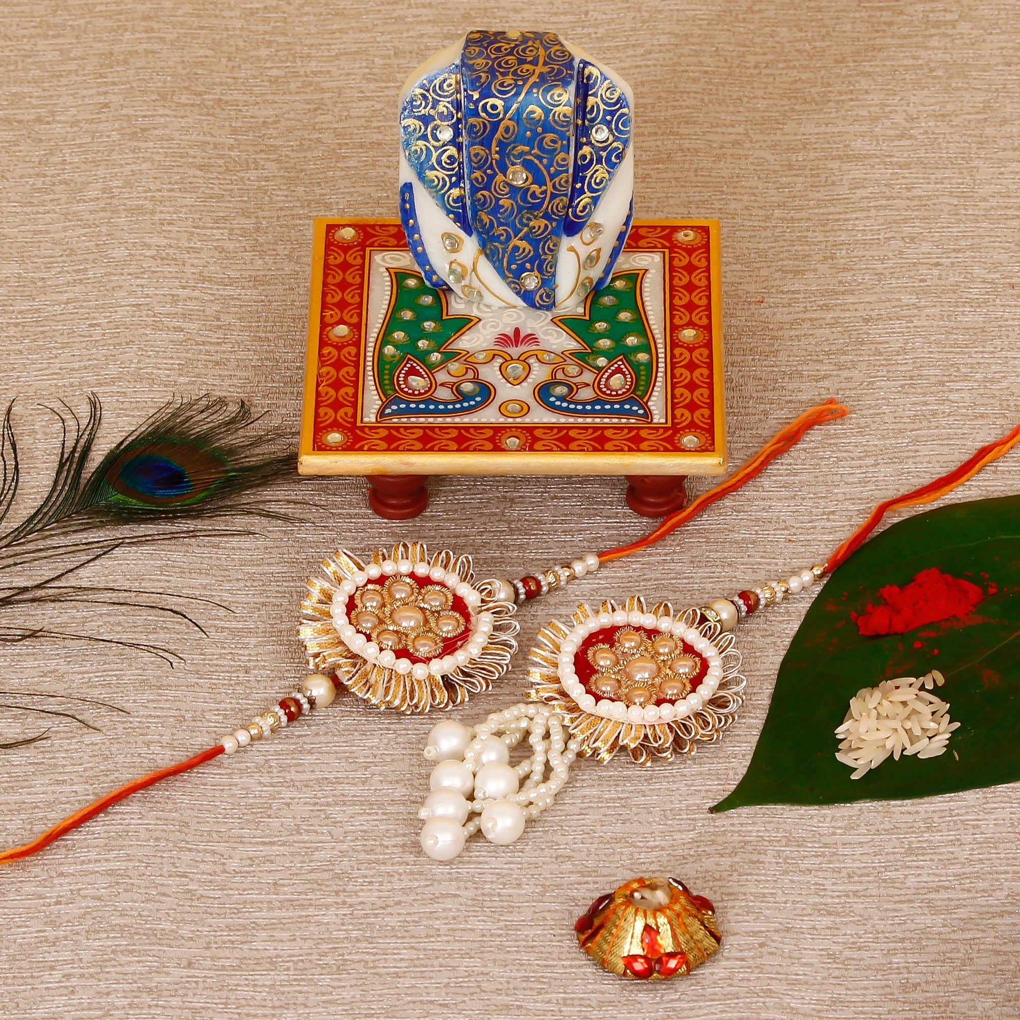 Designer Bhaiya Bhabhi Rakhi with Lord Ganesha on Marble Chowki and Roli Tikka Matki Kafalo