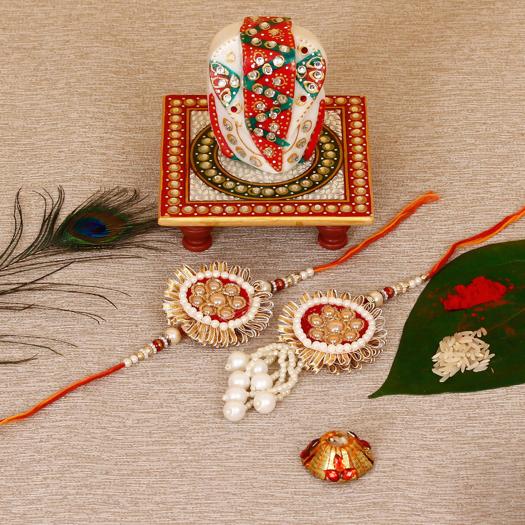 Designer Bhaiya Bhabhi Rakhi with Lord Ganesha on Kundan Studded Marble Chowki and Roli Tikka Matki Kafalo