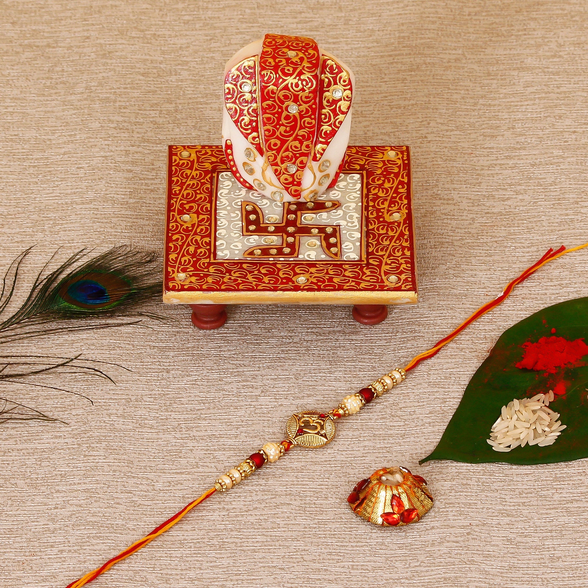 Designer OM Rakhi with Ridhi Sidhi Marble chowki and Roli Tikka Matki Kafalo