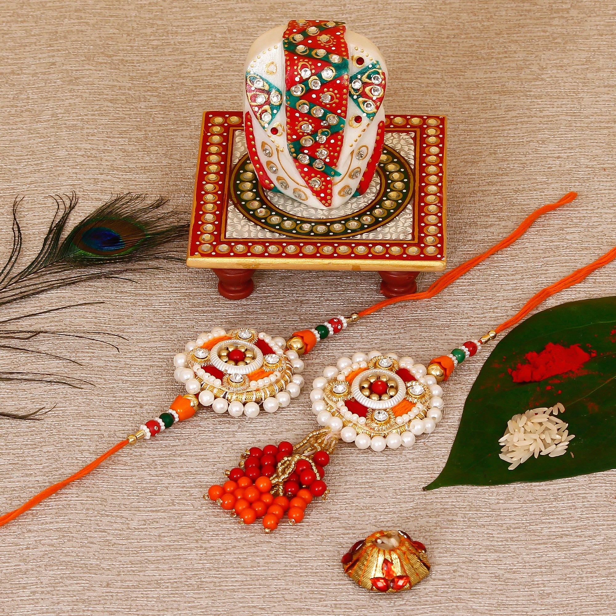 Designer Bhaiya Bhabhi Rakhi with Lord Ganesha on Kundan Studded Marble Chowki and Roli Tikka Matki Kafalo