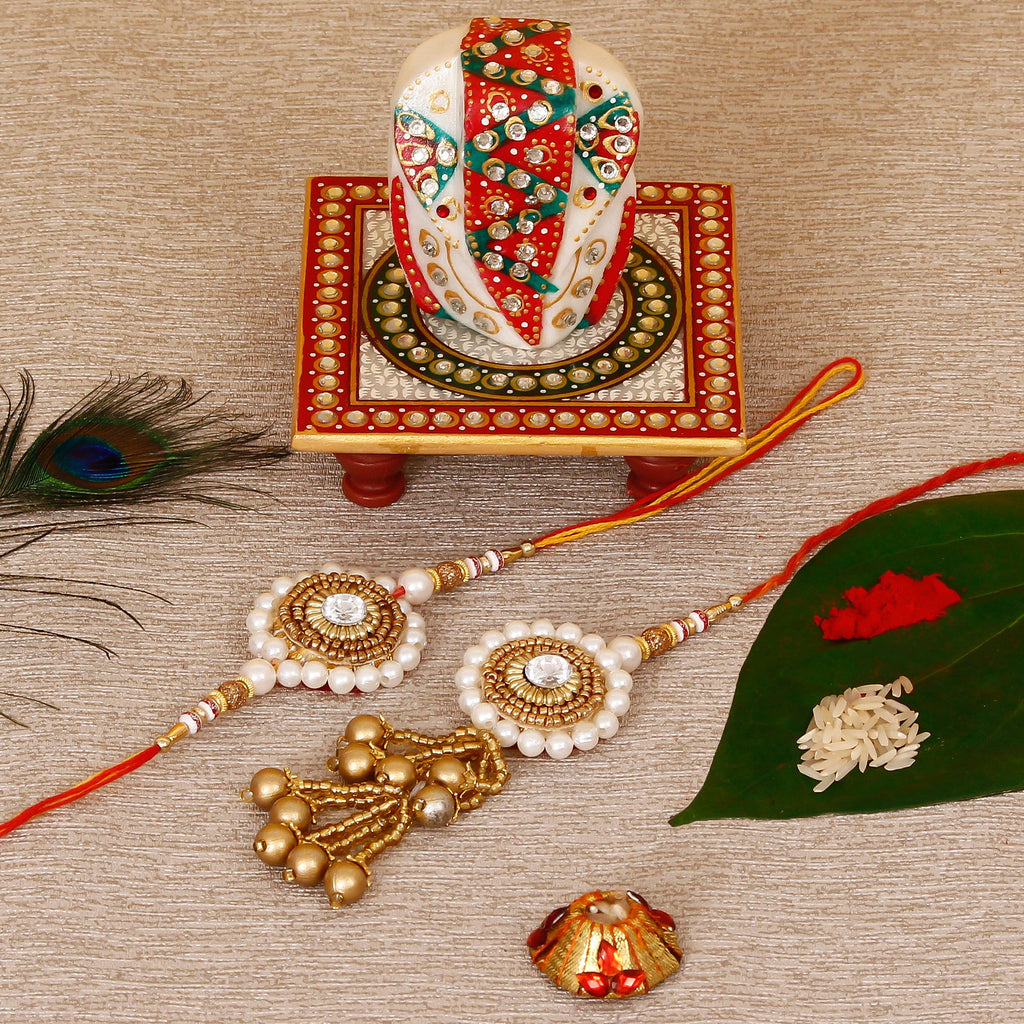 Designer Bhaiya Bhabhi Rakhi with Lord Ganesha on Kundan Studded Marble Chowki and Roli Tikka Matki Kafalo