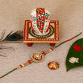 Designer Rakhi with Lord Ganesha on Kundan Studded Marble Chowki and Roli Tikka Matki Kafalo
