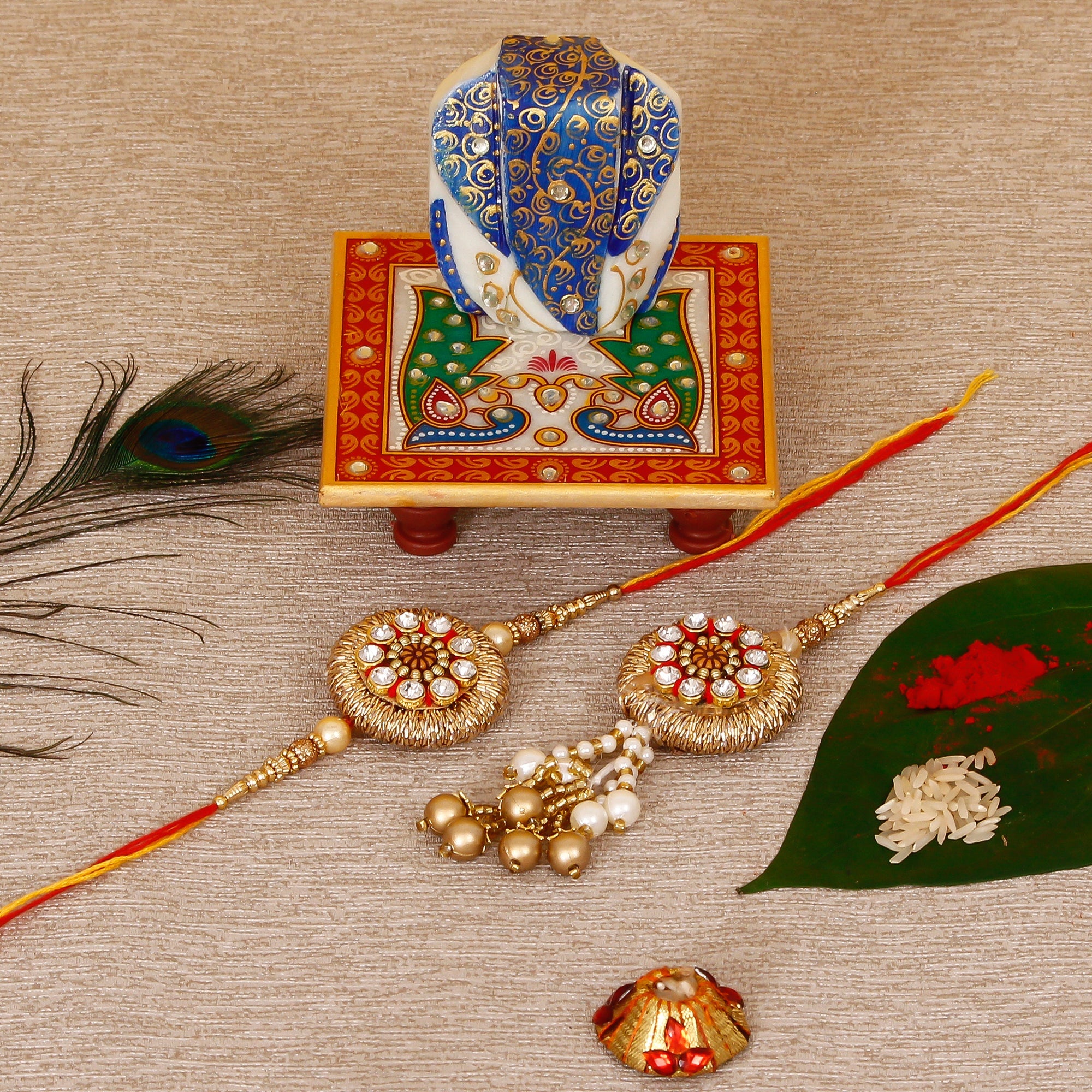 Designer Bhaiya Bhabhi Rakhi with Lord Ganesha on Marble Chowki and Roli Tikka Matki Kafalo