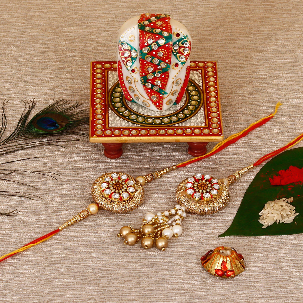 Designer Bhaiya Bhabhi Rakhi with Lord Ganesha on Kundan Studded Marble Chowki and Roli Tikka Matki Kafalo