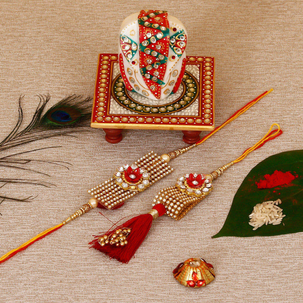 Designer Bhaiya Bhabhi Rakhi with Lord Ganesha on Kundan Studded Marble Chowki and Roli Tikka Matki Kafalo