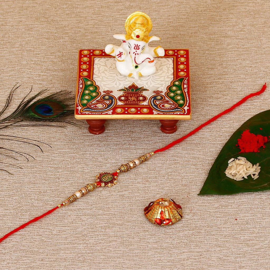 Designer Rakhi with Lord Ganesha Marble Chowki and Roli Tikka Matki Kafalo