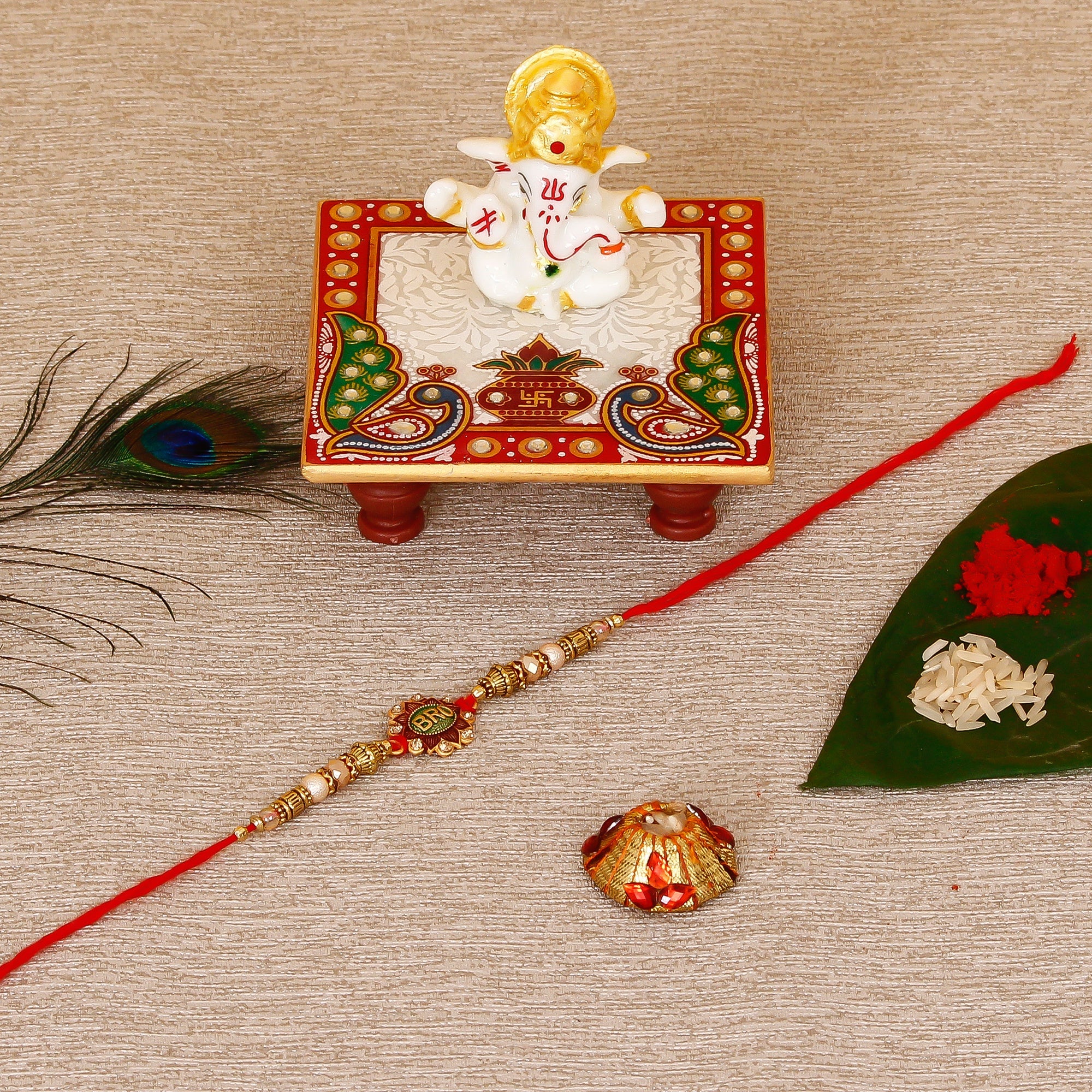 Designer Rakhi with Lord Ganesha Marble Chowki and Roli Tikka Matki Kafalo