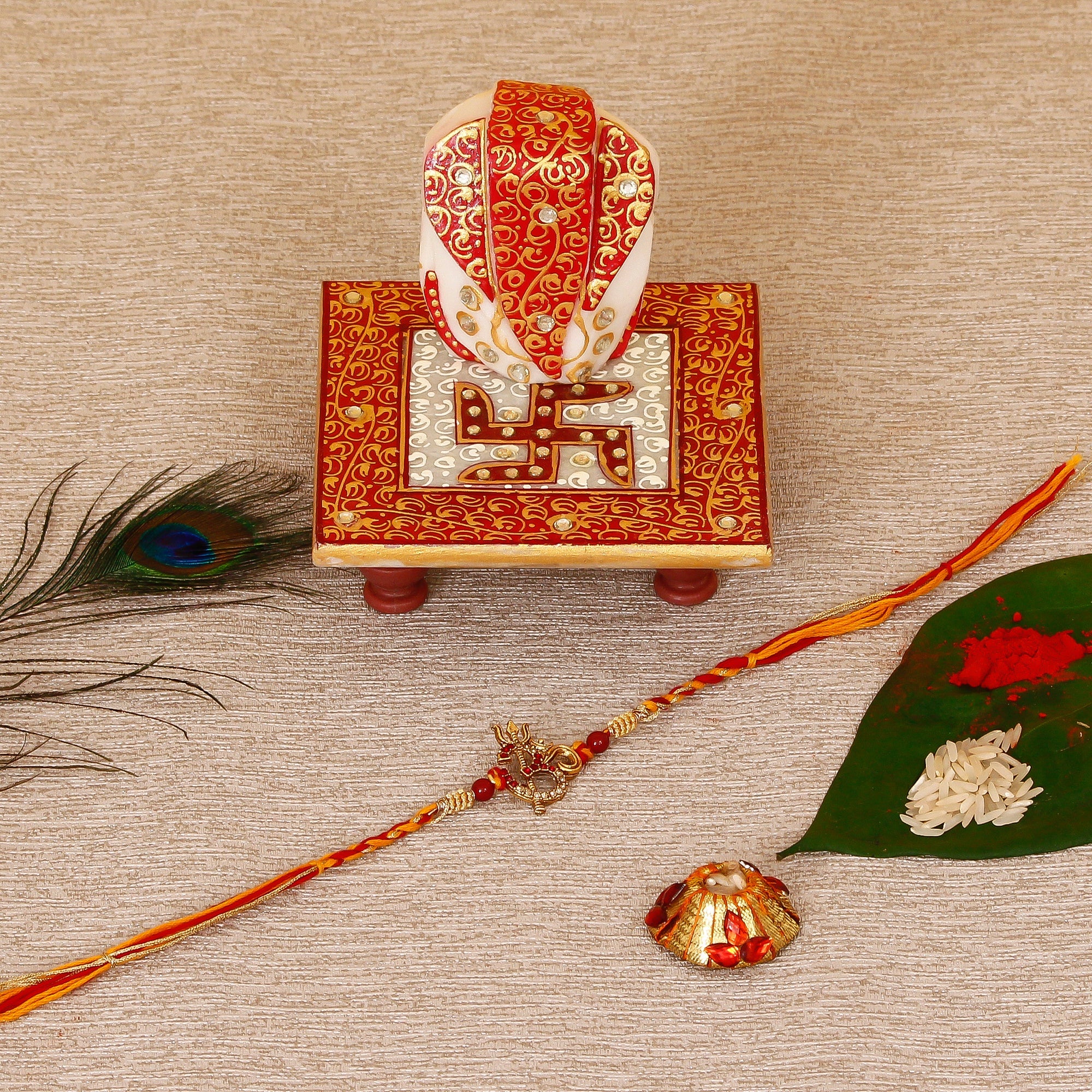 Designer Religious OM Rakhi with Ridhi Sidhi Marble chowki and Roli Tikka Matki Kafalo