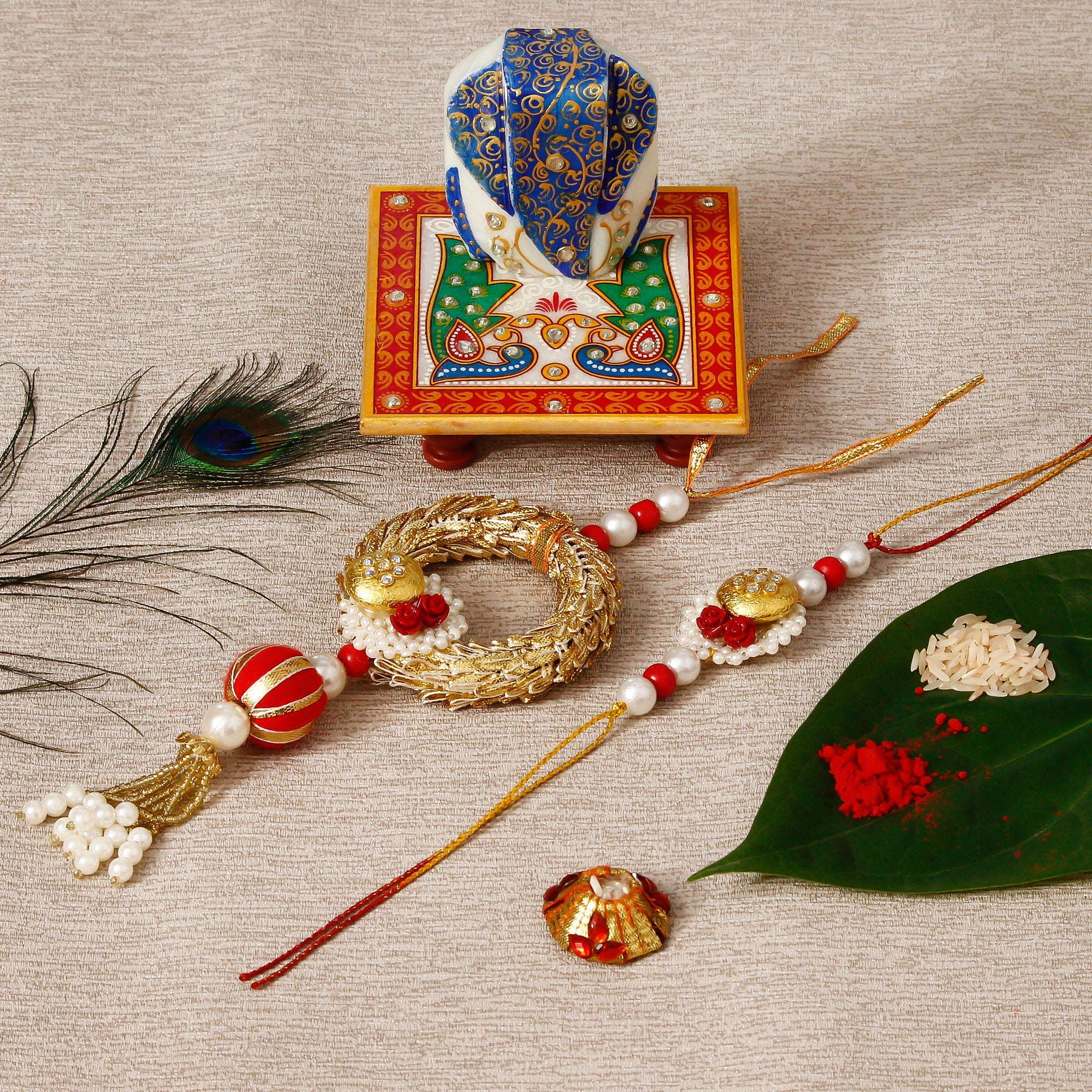 Designer Bhaiya Bhabhi Rakhi with Lord Ganesha on Marble Chowki and Roli Tikka Matki Kafalo