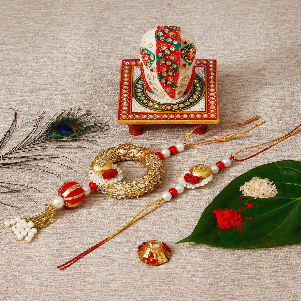 Designer Bhaiya Bhabhi Rakhi with Lord Ganesha on Kundan Studded Marble Chowki and Roli Tikka Matki Kafalo