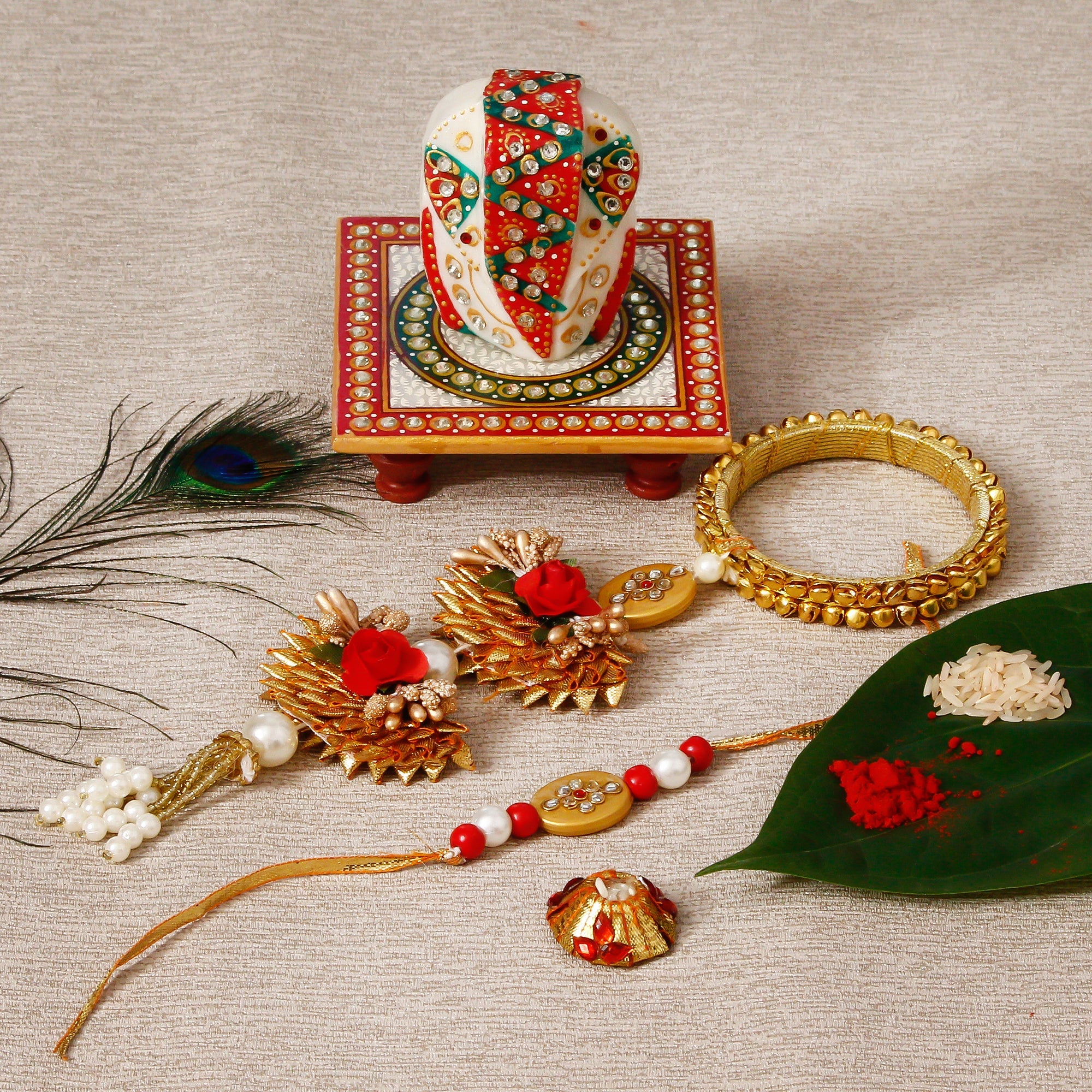 Designer Bhaiya Bhabhi Rakhi with Lord Ganesha on Kundan Studded Marble Chowki and Roli Tikka Matki Kafalo