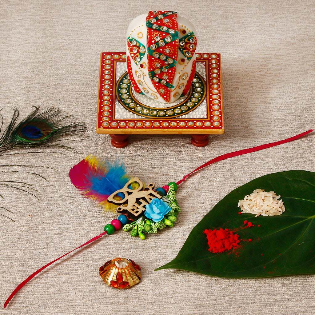 Designer Rakhi with Lord Ganesha on Kundan Studded Marble Chowki and Roli Tikka Matki Kafalo