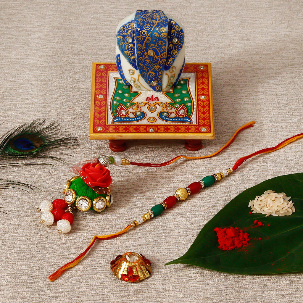 Designer Bhaiya Bhabhi Rakhi with Lord Ganesha on Marble Chowki and Roli Tikka Matki Kafalo