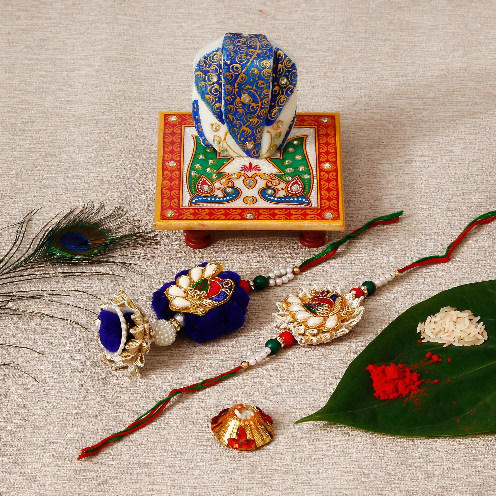 Designer Bhaiya Bhabhi Rakhi with Lord Ganesha on Marble Chowki and Roli Tikka Matki Kafalo