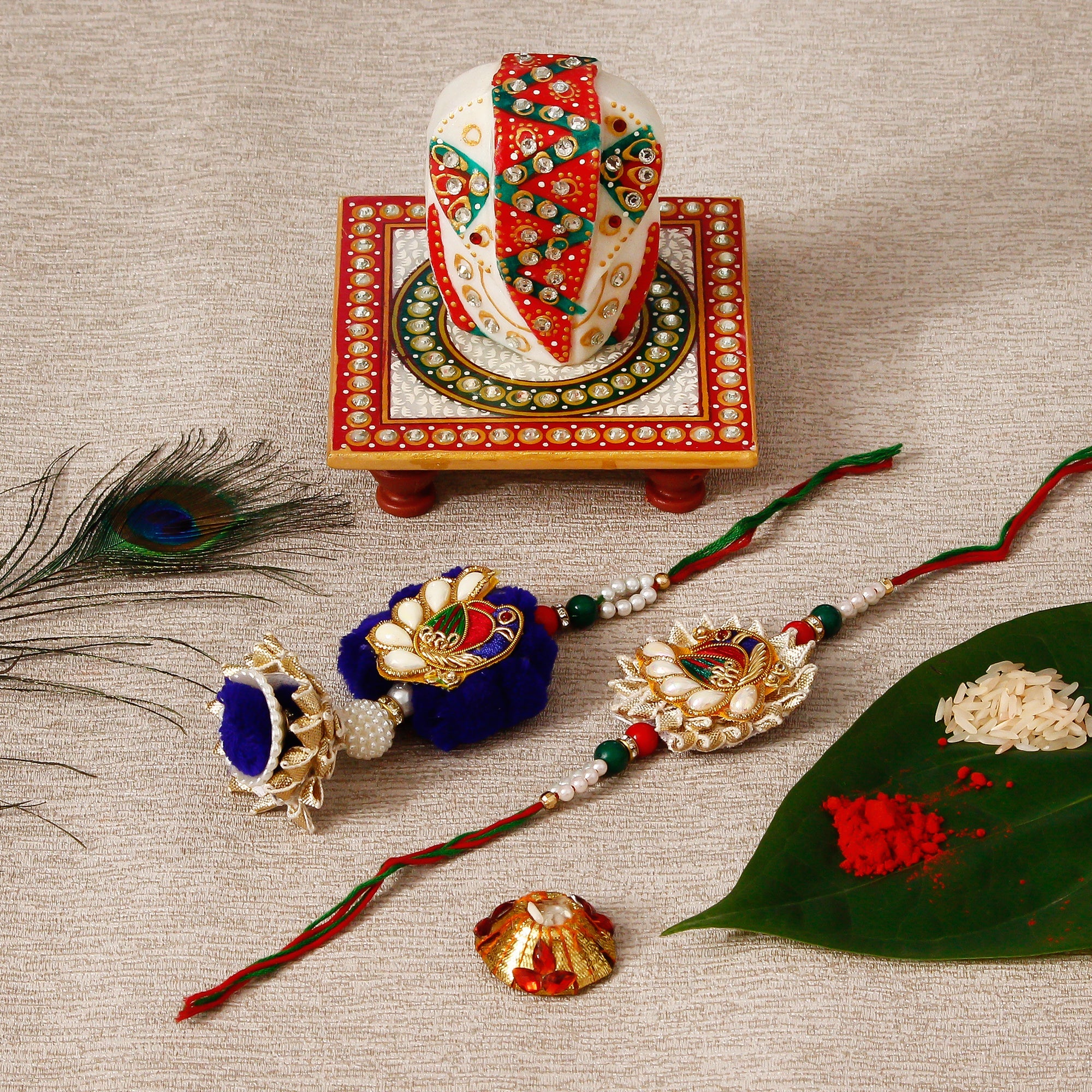 Designer Bhaiya Bhabhi Rakhi with Lord Ganesha on Kundan Studded Marble Chowki and Roli Tikka Matki Kafalo