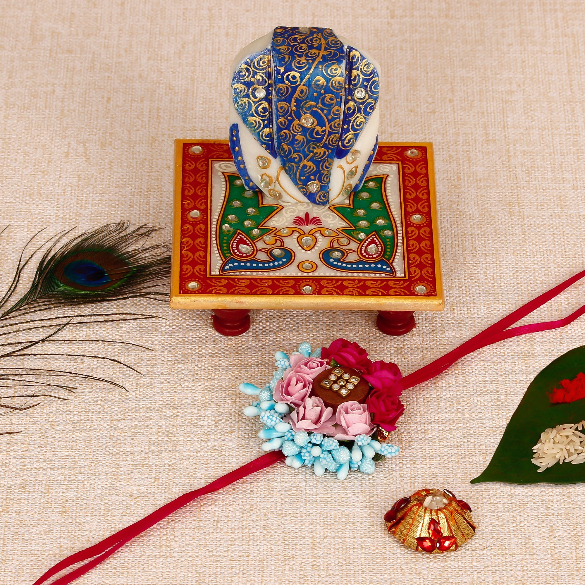 Designer Floral Rakhi with Lord Ganesha on Marble Chowki and Roli Tikka Matki Kafalo