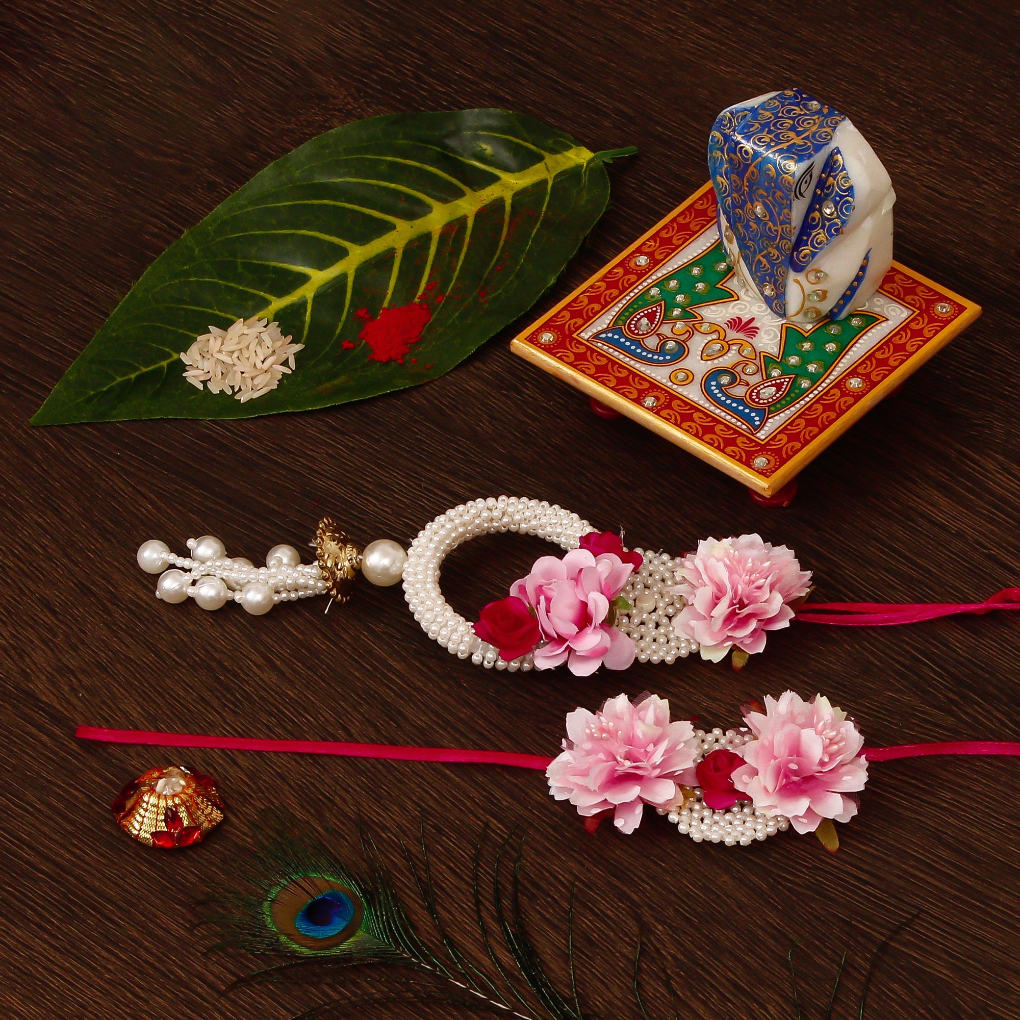 Floral Bhaiya Bhabhi Rakhi with Lord Ganesha on Marble Chowki and Roli Tikka Matki Kafalo