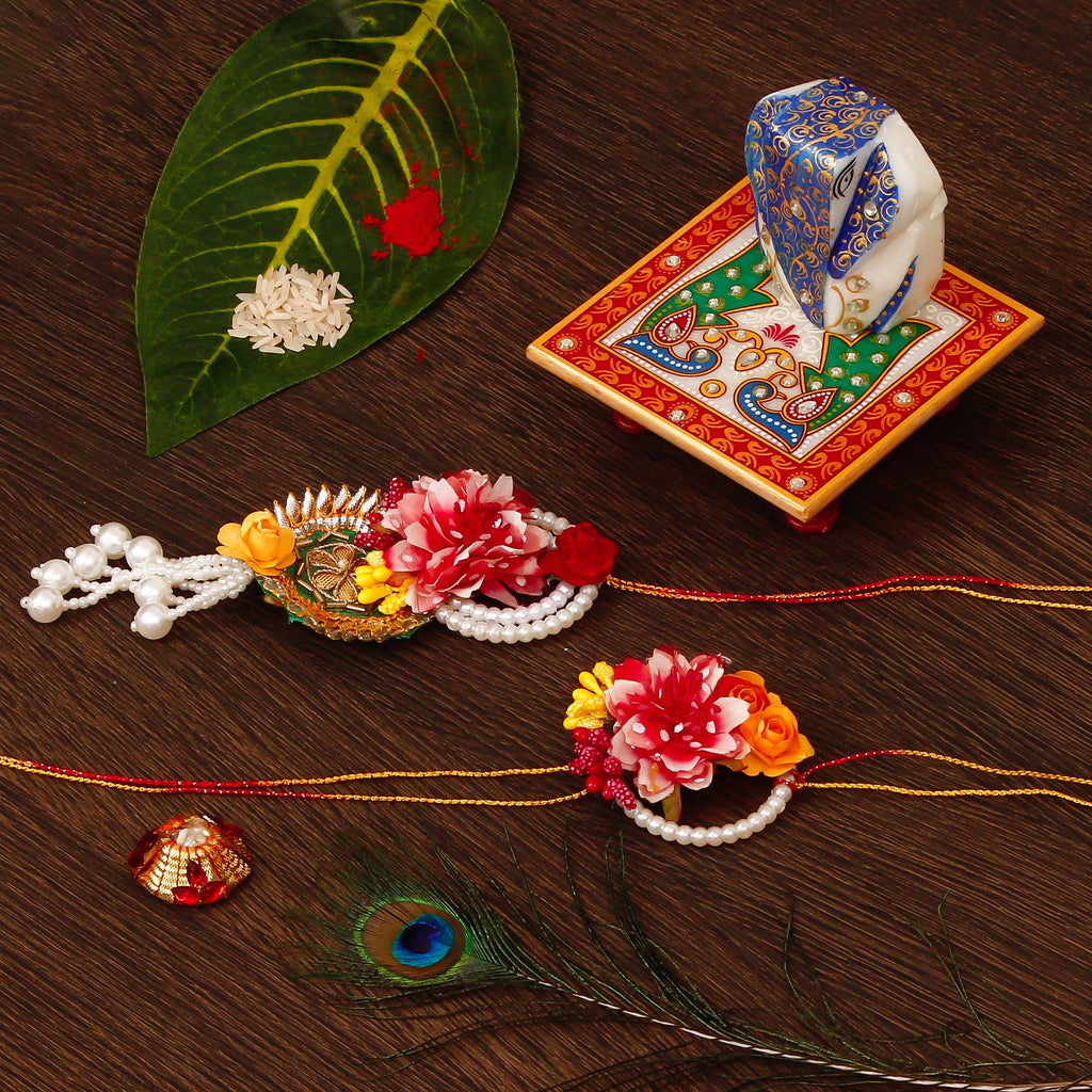 Floral Bhaiya Bhabhi Rakhi with Lord Ganesha on Marble Chowki and Roli Tikka Matki Kafalo