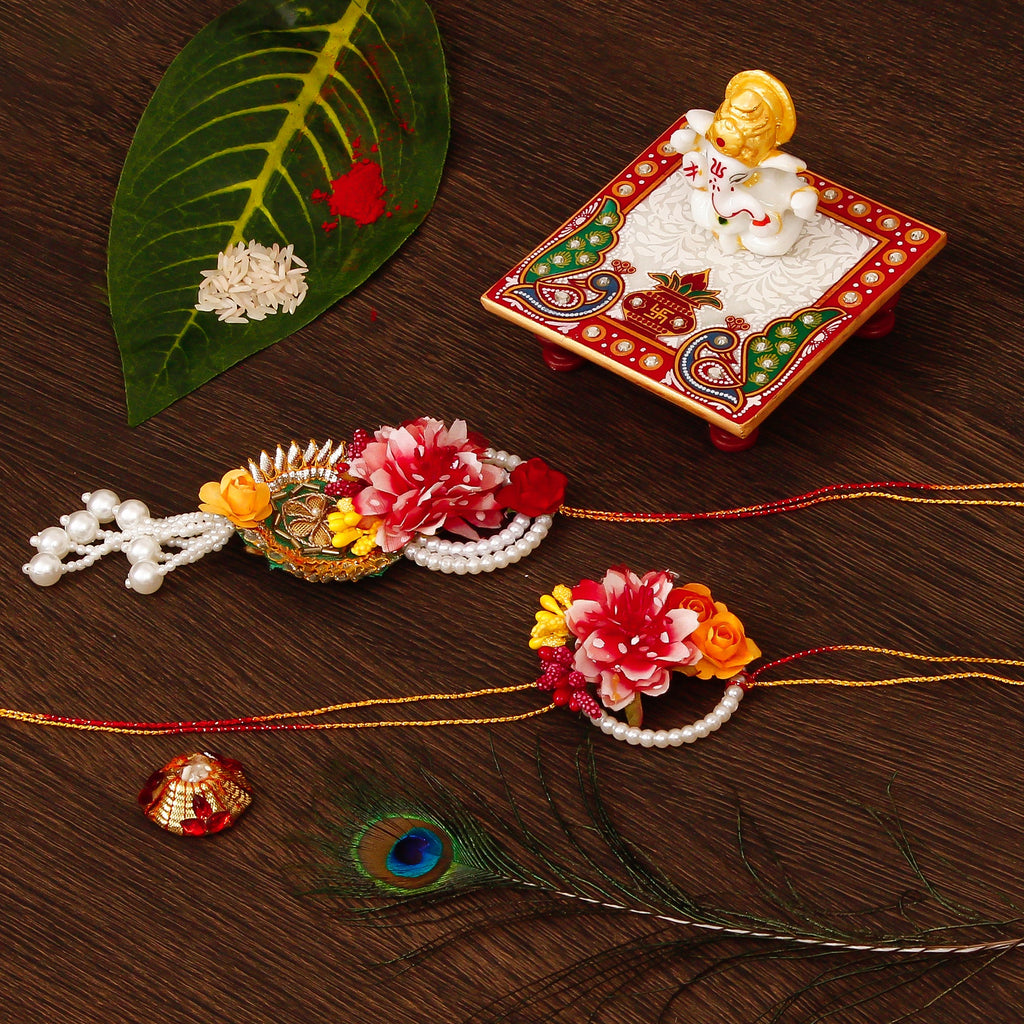 Floral Bhaiya Bhabhi Rakhi with Lord Ganesha Marble Chowki and Roli Tikka Matki Kafalo