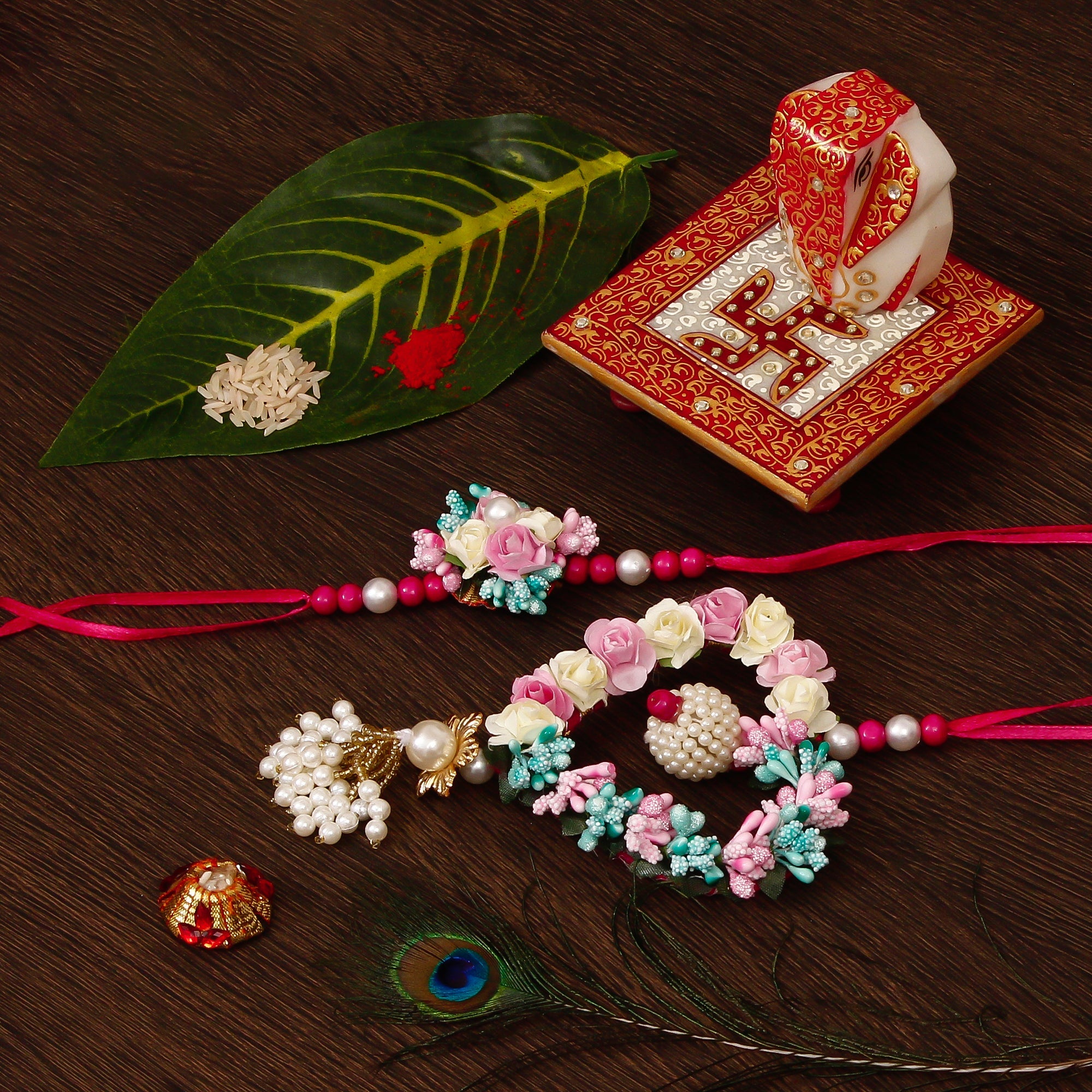 Floral and Heart Shape Bhaiya Bhabhi Rakhi with Ridhi Sidhi Marble chowki and Roli Tikka Matki Kafalo