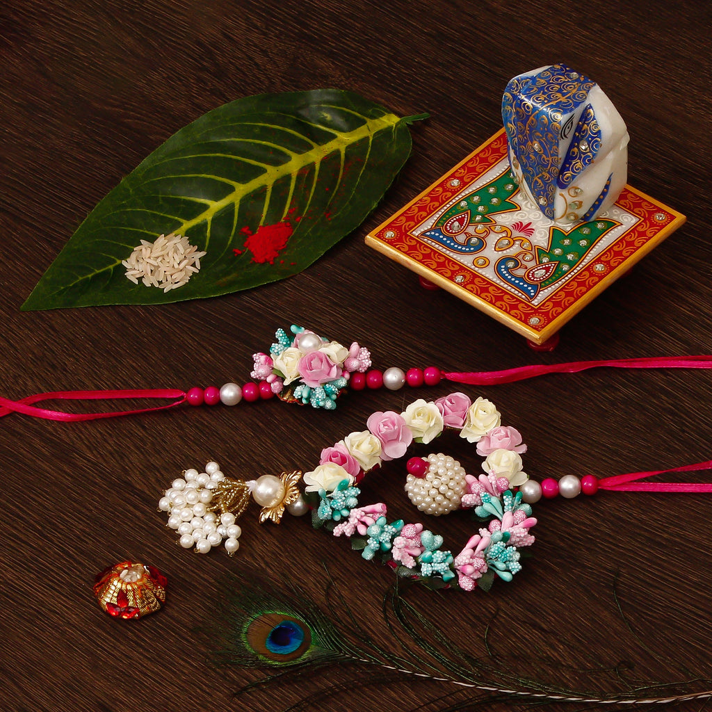 Floral and Heart Shape Bhaiya Bhabhi Rakhi with Lord Ganesha on Marble Chowki and Roli Tikka Matki Kafalo