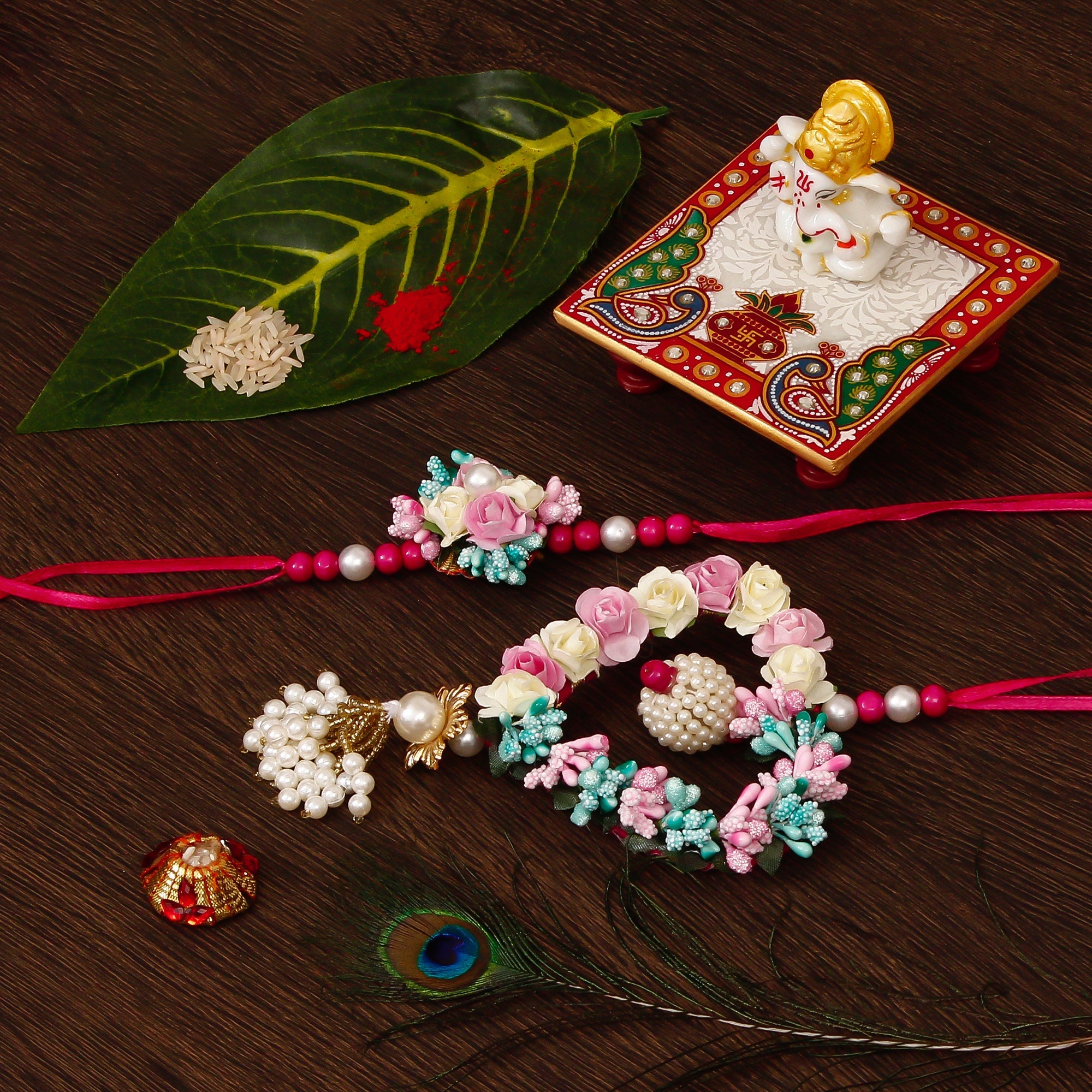 Floral and Heart Shape Bhaiya Bhabhi Rakhi with Lord Ganesha Marble Chowki and Roli Tikka Matki Kafalo