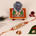 Designer Rakhi with Lord Ganesha on Marble Chowki and Roli Tikka Matki Kafalo