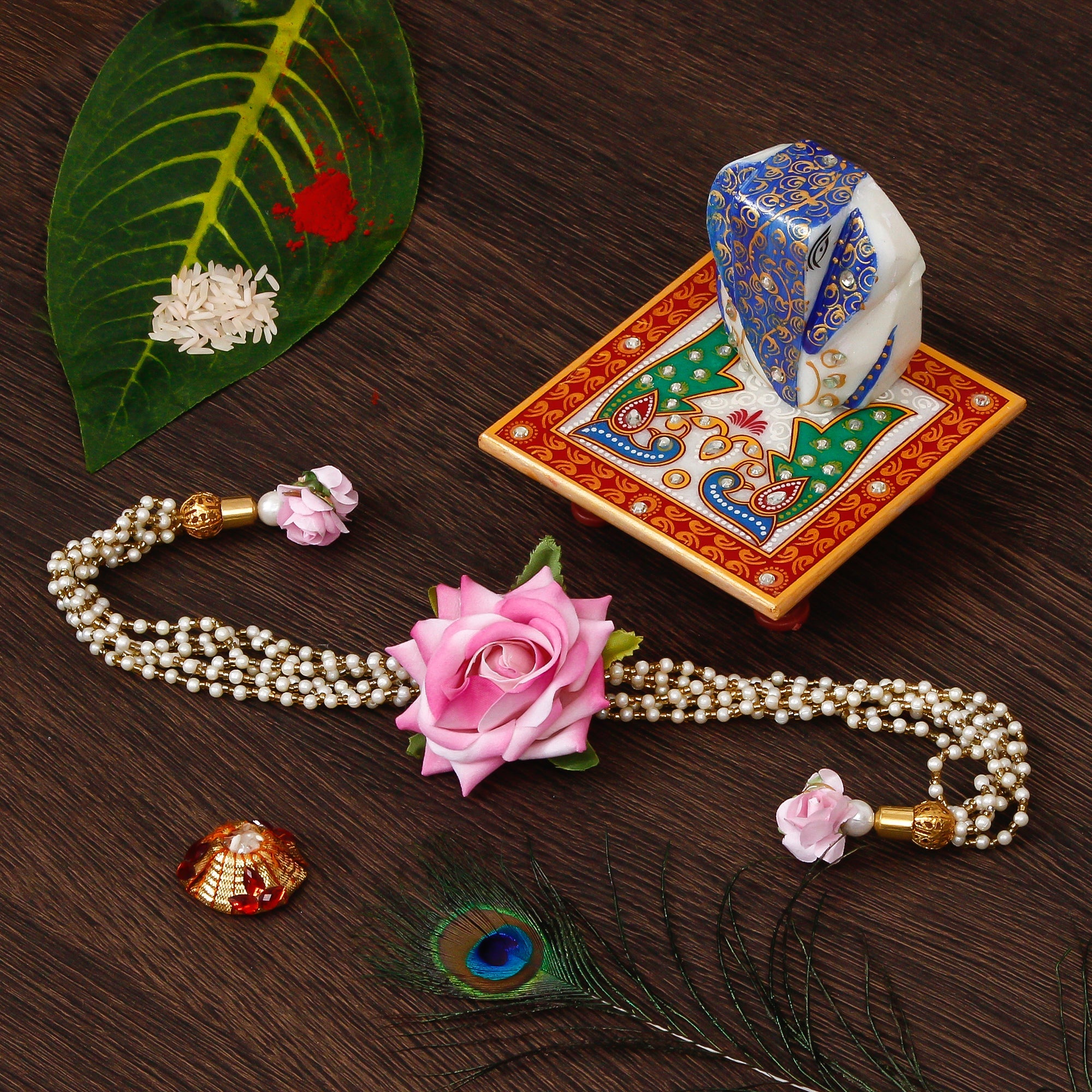 Floral Rakhi for Bhabhi with Lord Ganesha on Marble Chowki and Roli Tikka Matki Kafalo