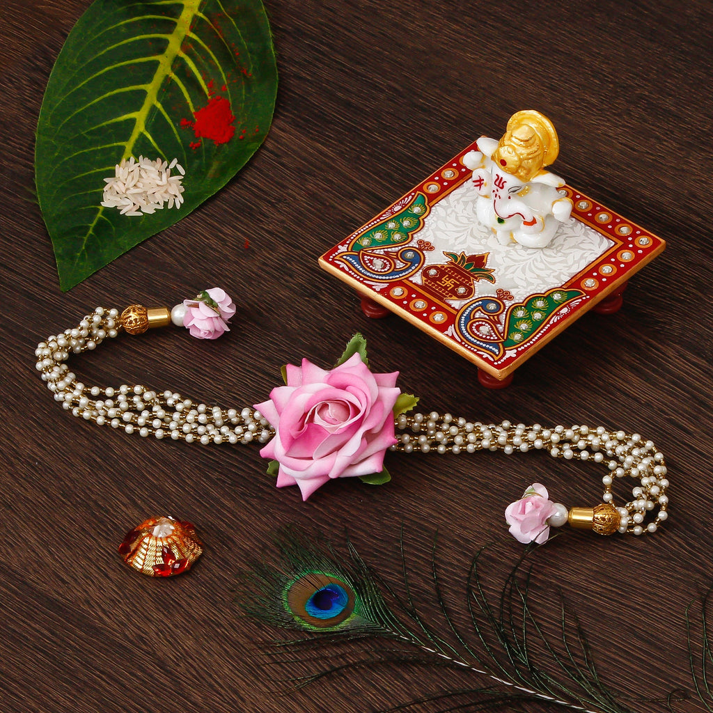 Floral Rakhi for Bhabhi with Lord Ganesha Marble Chowki and Roli Tikka Matki Kafalo