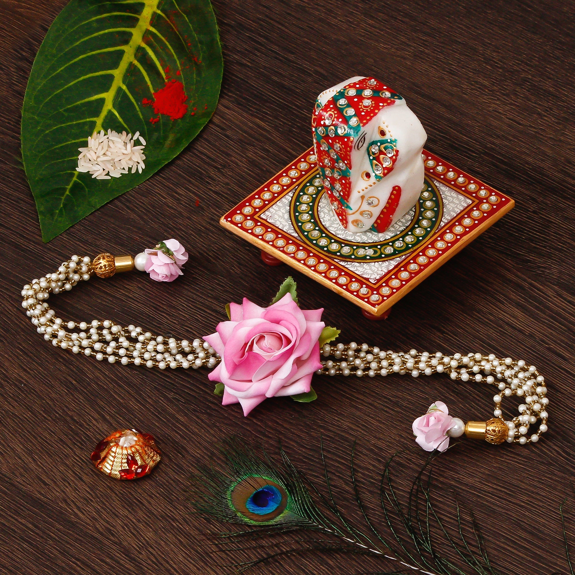 Floral Rakhi for Bhabhi with Lord Ganesha on Kundan Studded Marble Chowki and Roli Tikka Matki Kafalo