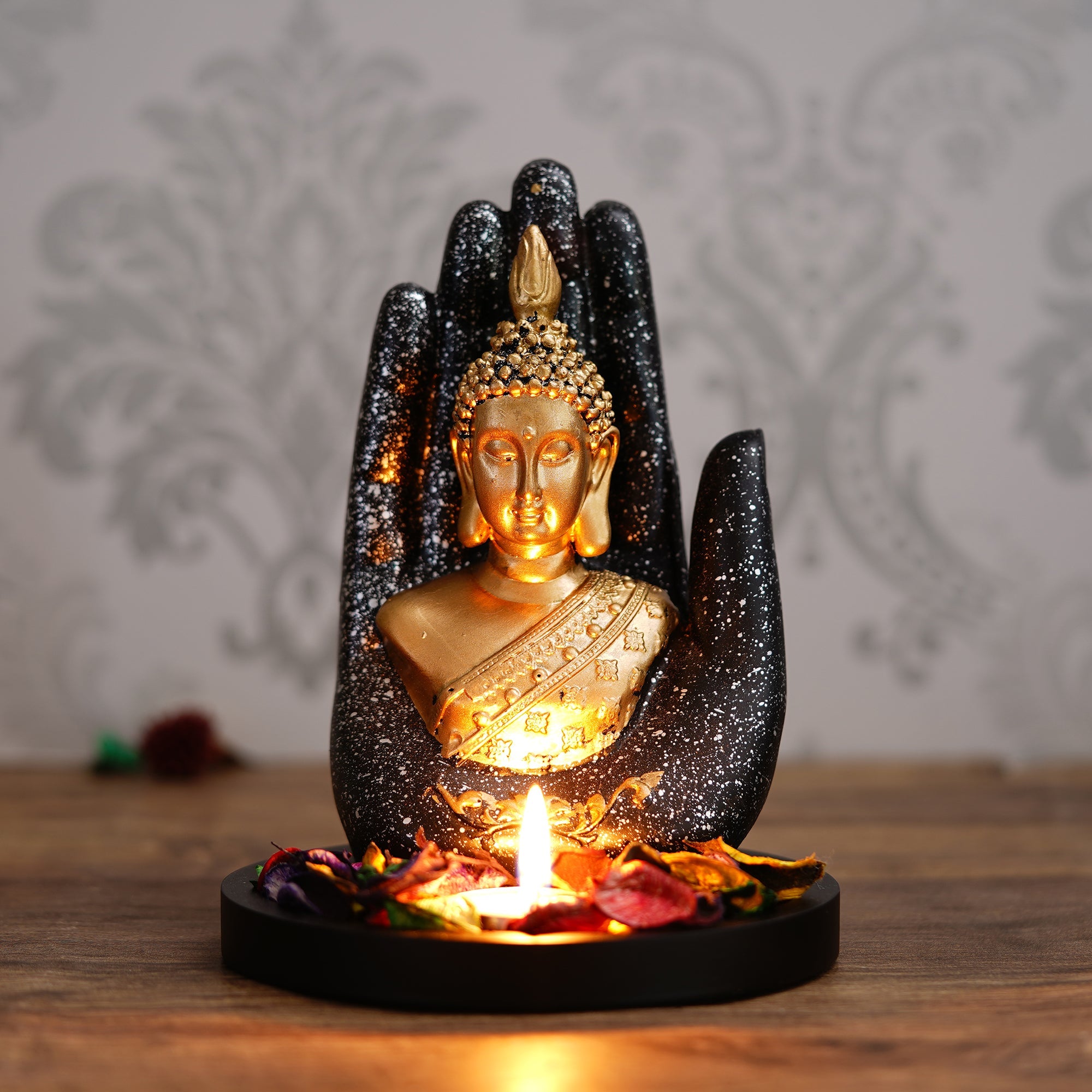 Polyresin Black and Golden Handcrafted Palm Buddha Statue with Wooden Base, Fragranced Petals and Tealight Kafalo