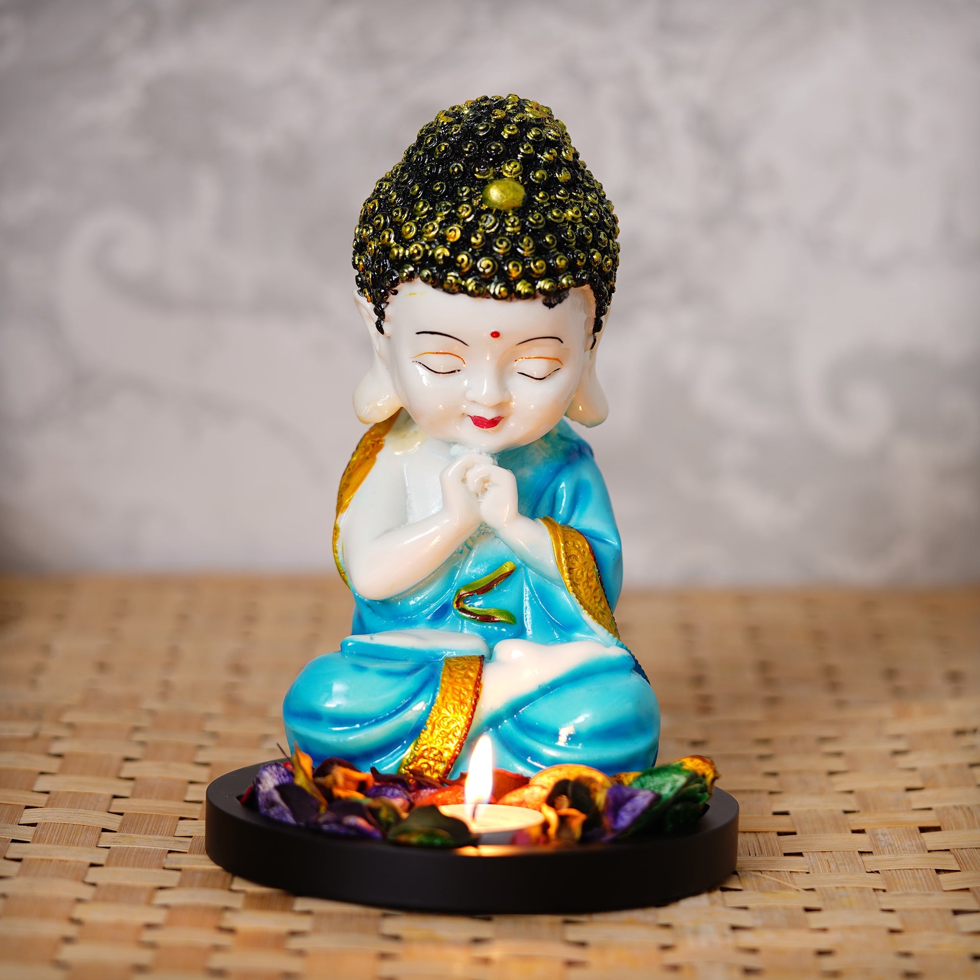 Polyresin Blue and White Praying Monk Buddha Statue with Wooden Base, Fragranced Petals and Tealight Kafalo