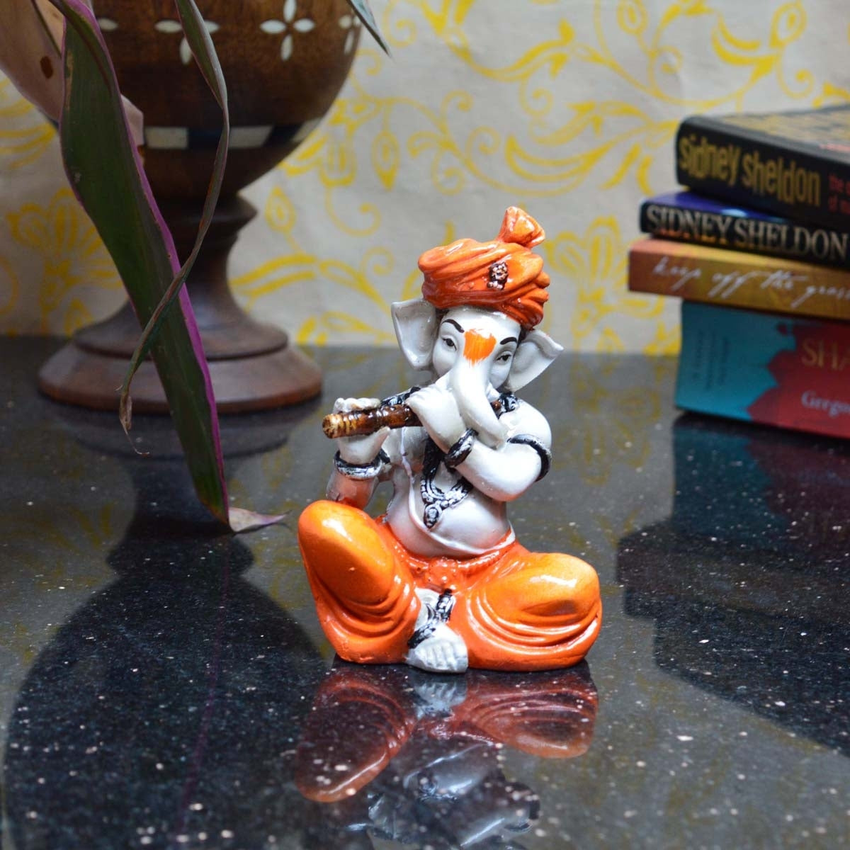 Orange Polyresin Lord Ganesha Playing Flute Idol Kafalo