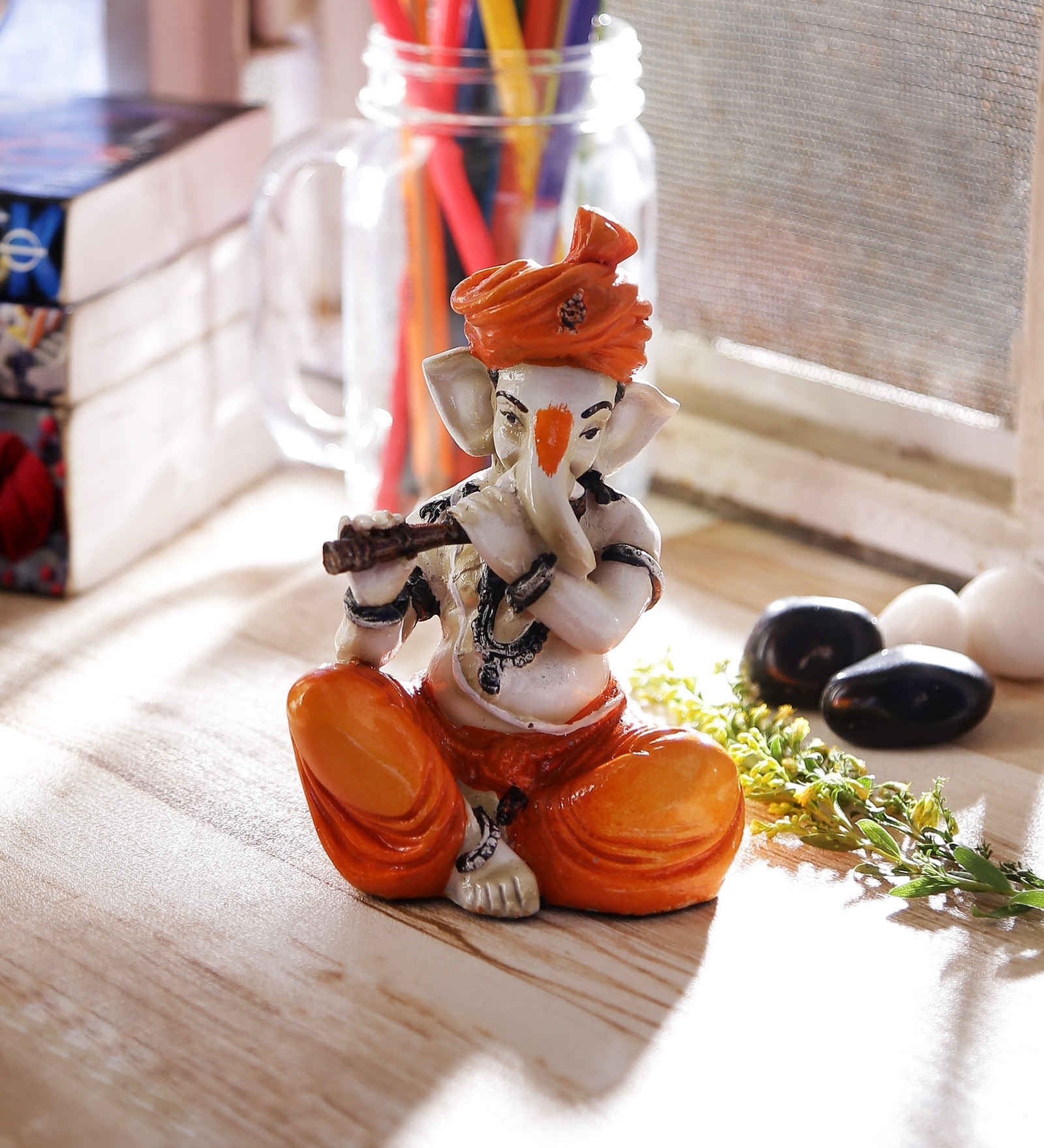 Orange Polyresin Lord Ganesha Playing Flute Idol Kafalo
