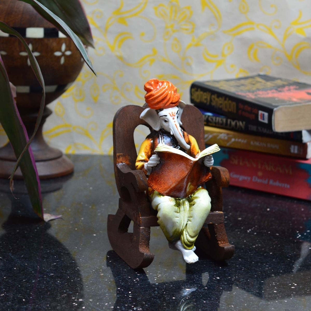 Orange Polyresin Lord Ganesha Idol reading Book on Wooden Chair Kafalo