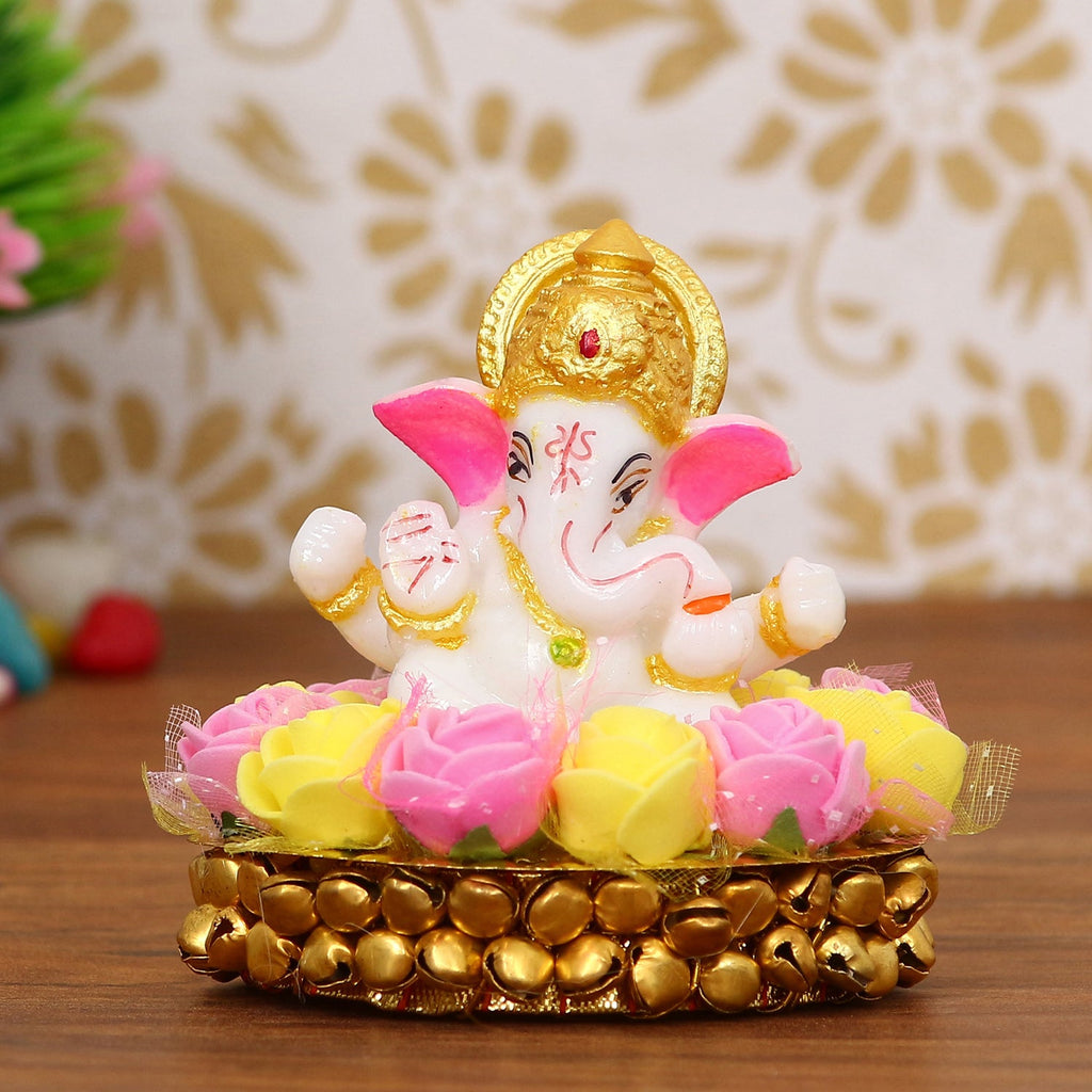 Golden and White Polyresin Lord Ganesha Idol on Decorative Handcrafted Plate with Pink and Yellow Flowers Kafalo