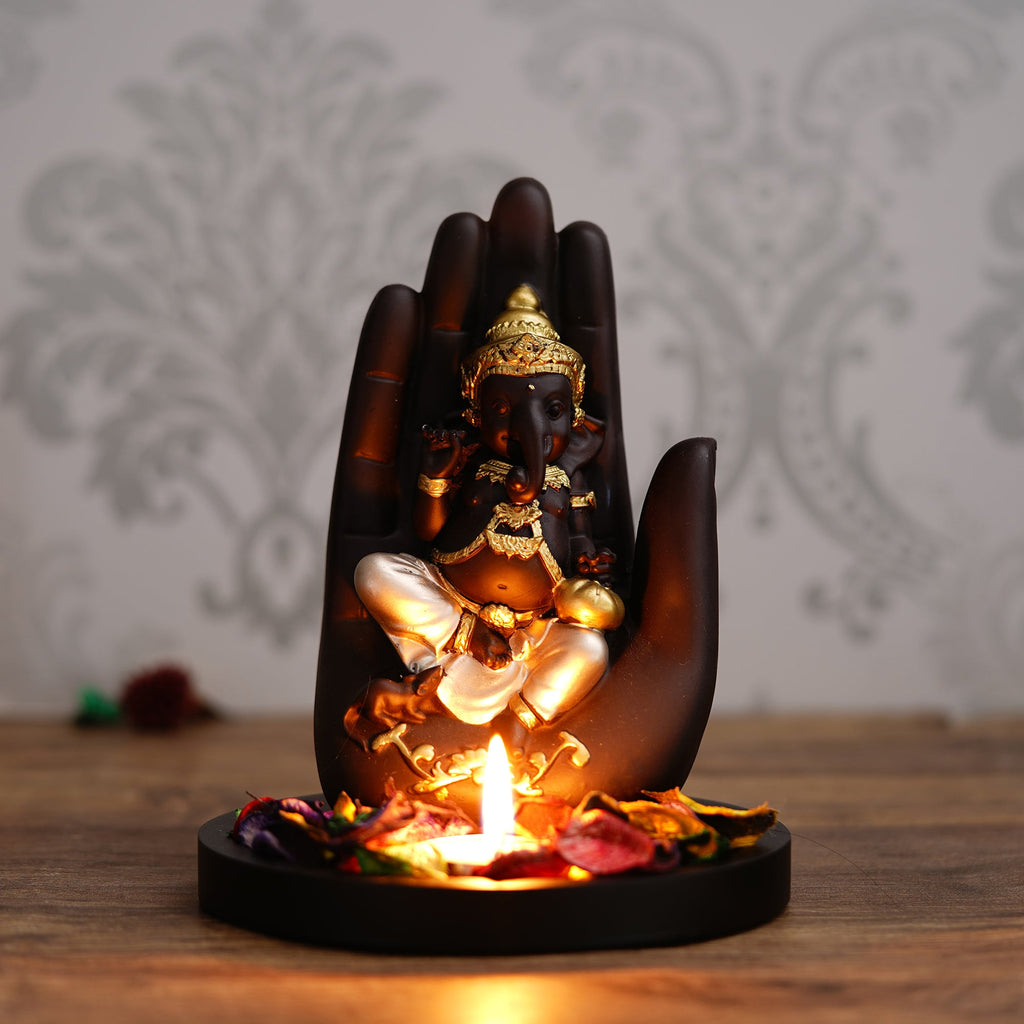Golden and Black Handcrafted Palm Ganesha Idol on Wooden Base with Fragranced Petals Tealight Candle Holder Kafalo