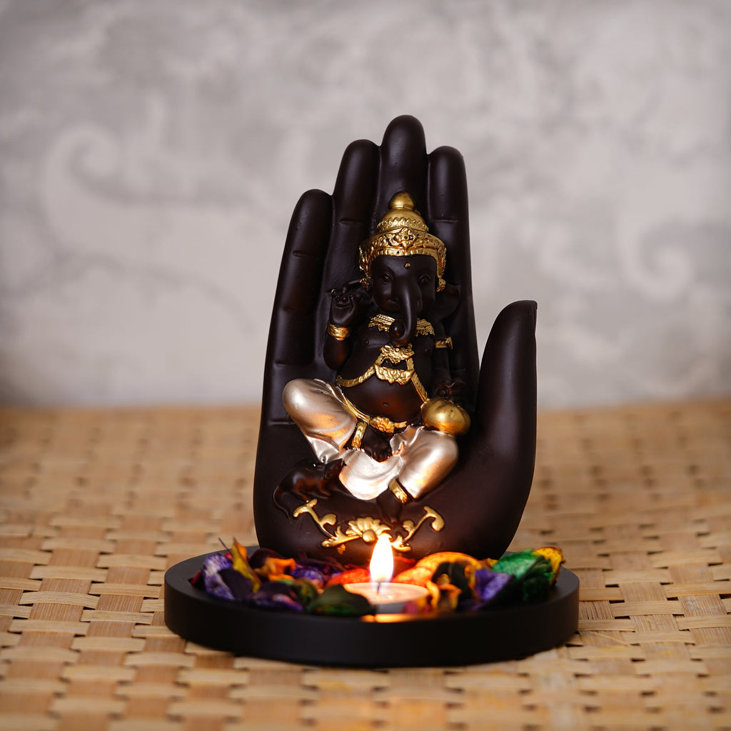 Golden and Black Handcrafted Palm Ganesha Idol on Wooden Base with Fragranced Petals Tealight Candle Holder Kafalo