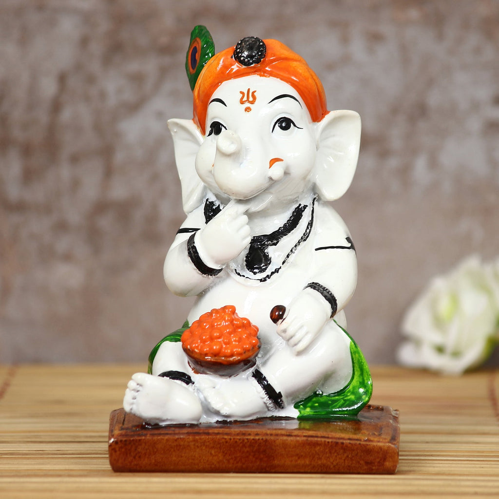 Decorative Polyresin Lord Ganesha Idol eating Ladoo in Lord Krishna Avatar (White, Orange, Green) Kafalo