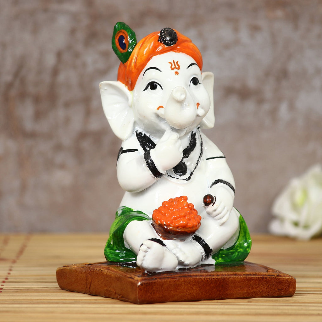 Decorative Polyresin Lord Ganesha Idol eating Ladoo in Lord Krishna Avatar (White, Orange, Green) Kafalo