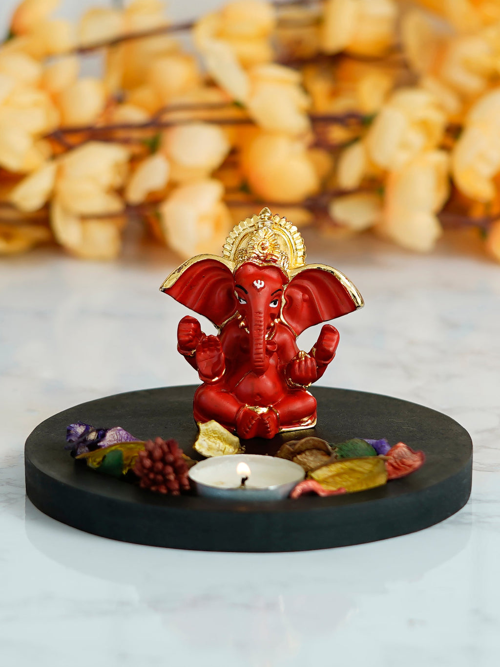 Gold Plated Red Ganesha Idol with Wooden Base, Fragranced Petals and Tealight Kafalo