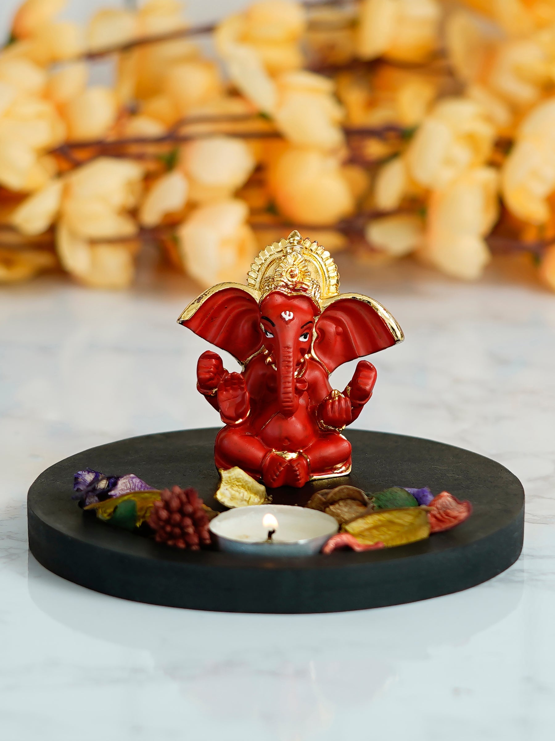 Gold Plated Red Ganesha Idol with Wooden Base, Fragranced Petals and Tealight Kafalo