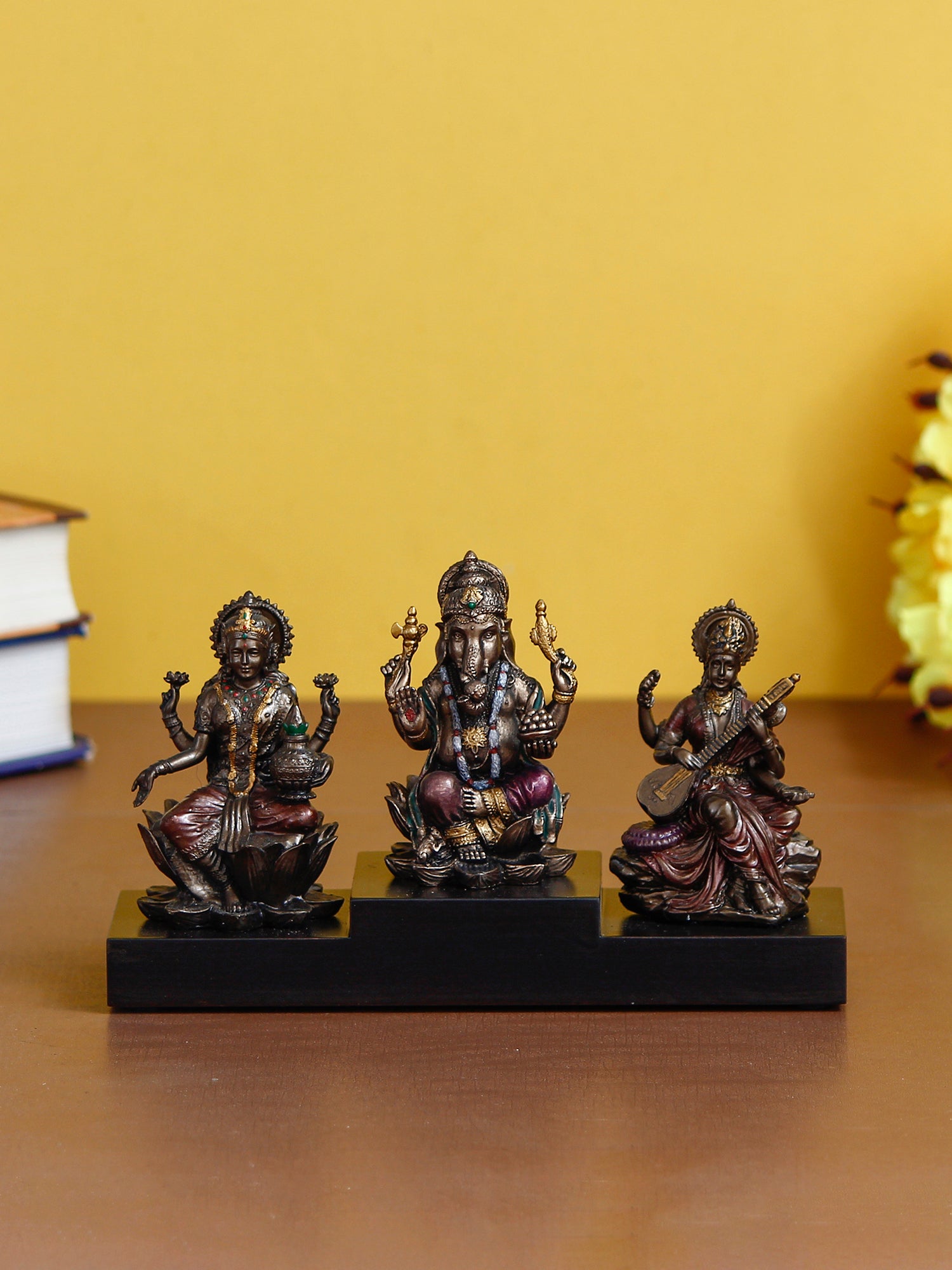 Brown Polyresin and Bronze Lakshmi Ganesha Saraswati Idols on Base Kafalo