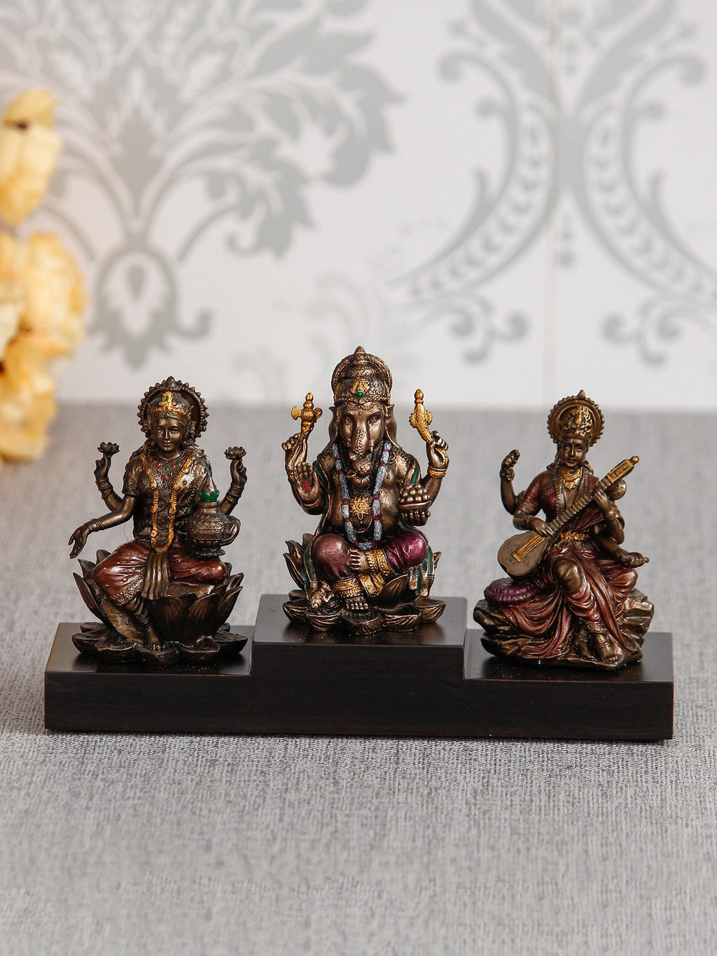 Brown Polyresin and Bronze Lakshmi Ganesha Saraswati Idols on Base Kafalo